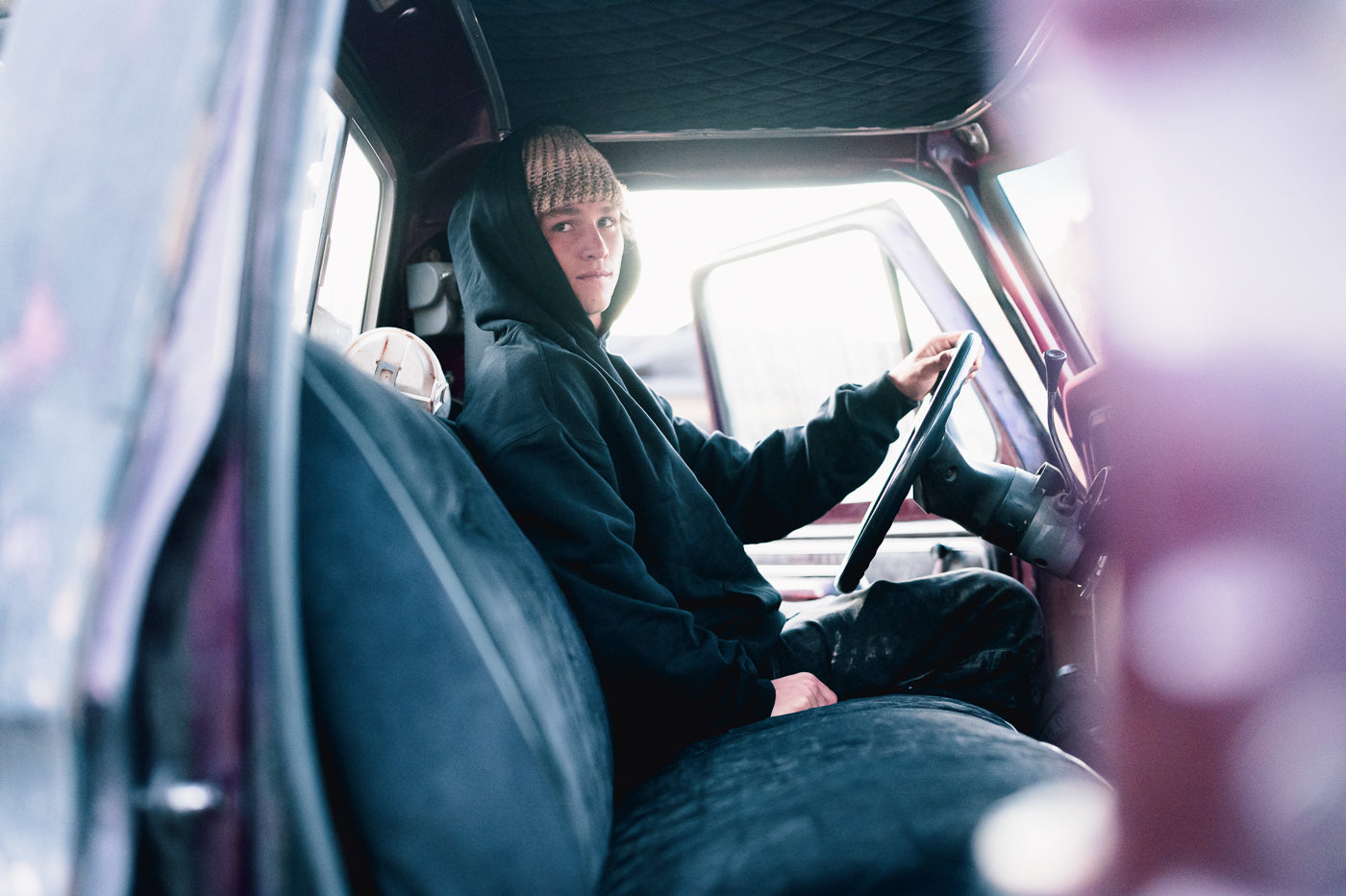 Person sitting inside a vehicle with a blurred background