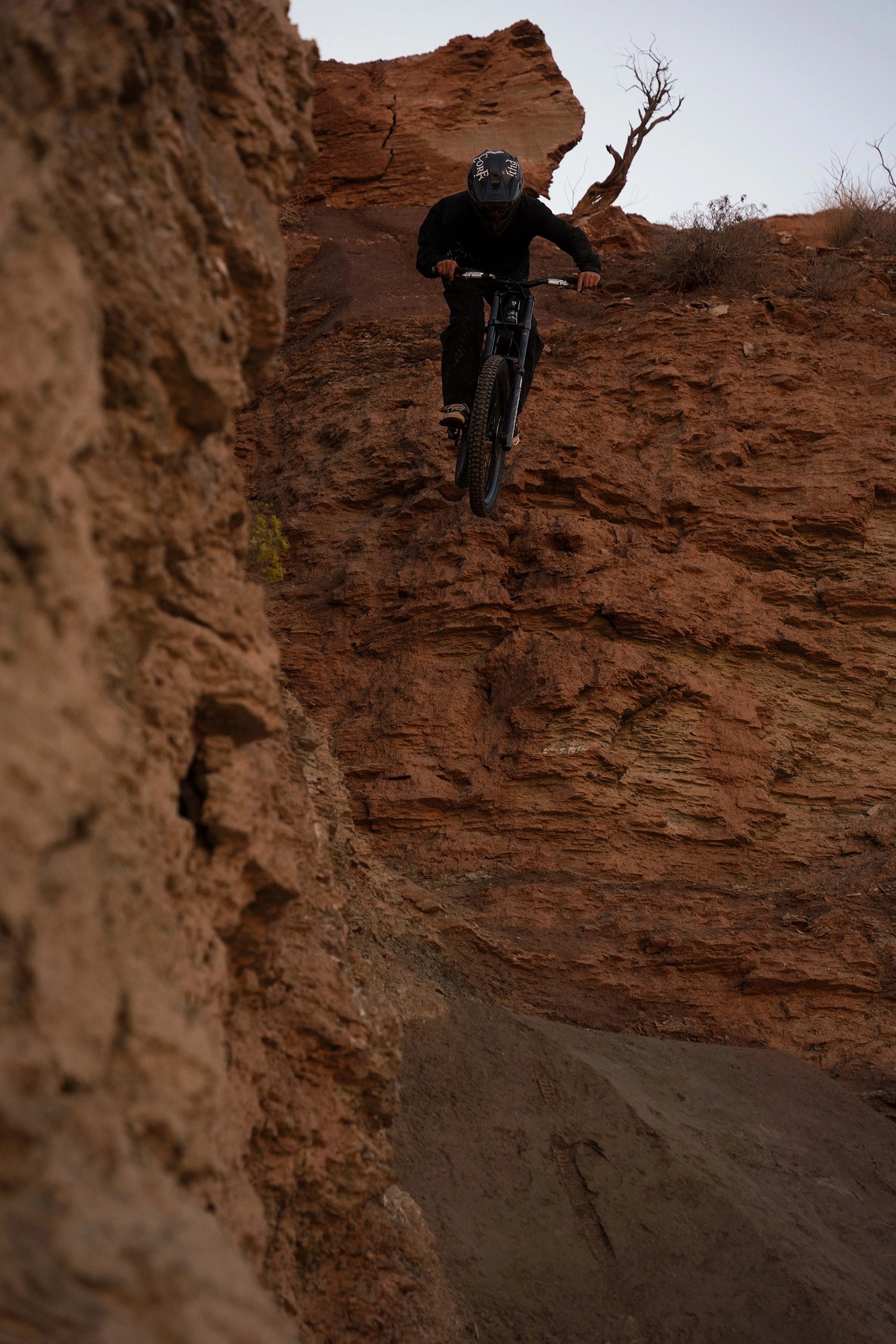 Person riding a bike on a rocky cliff face