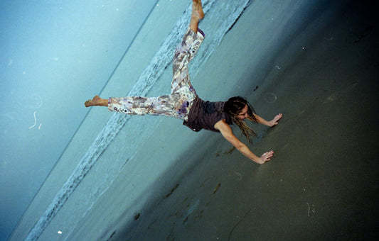 Nina doing a cartwheel on the beach
