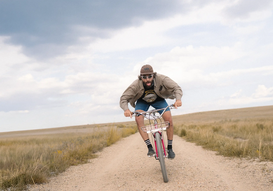 Man riding bike on gravel road