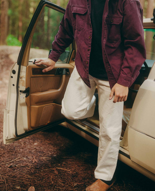Person getting into a car in a forest setting