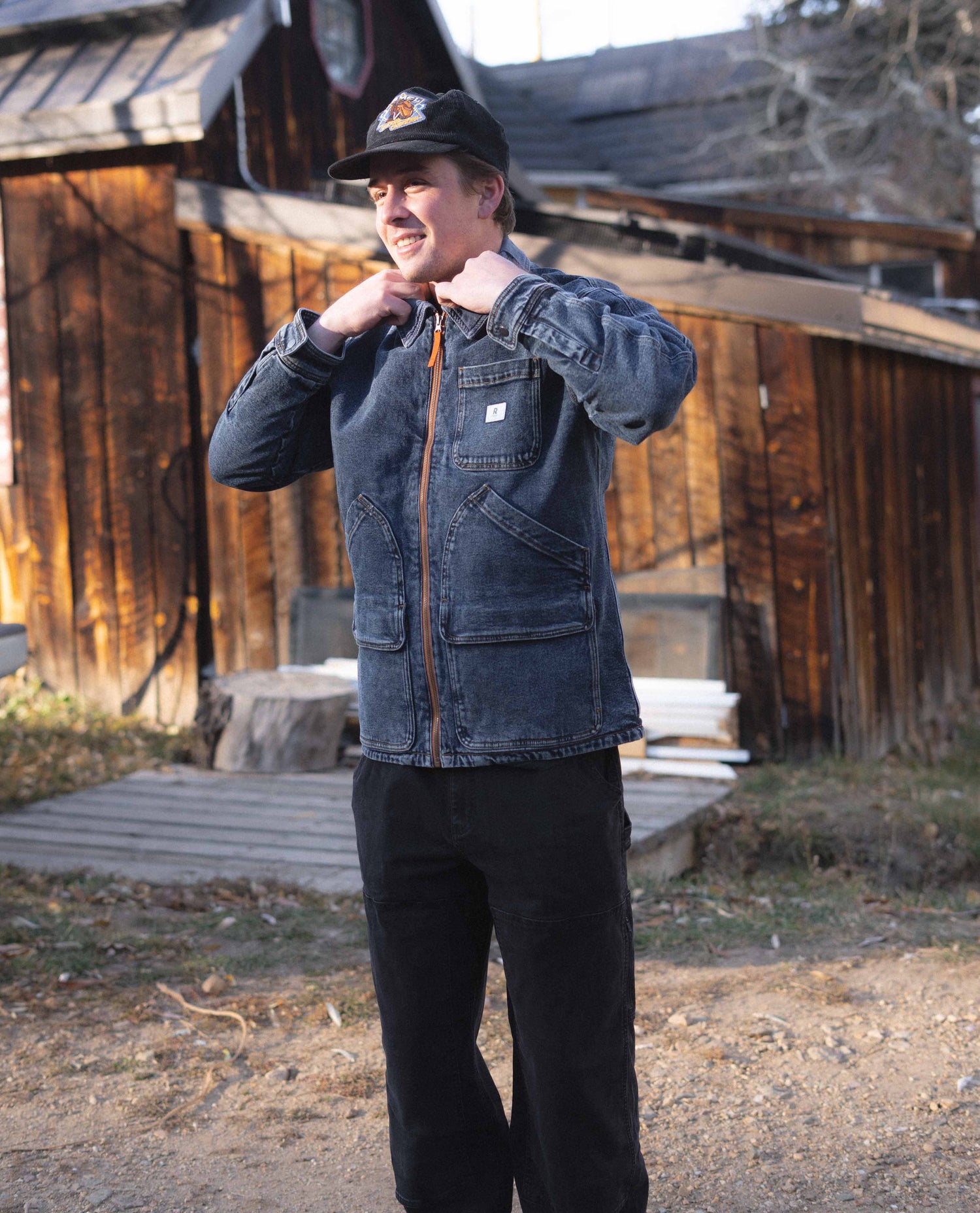 Guy wearing a denim jacket. Color:Dark
