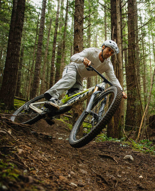 Person riding a mountain bike through a forest