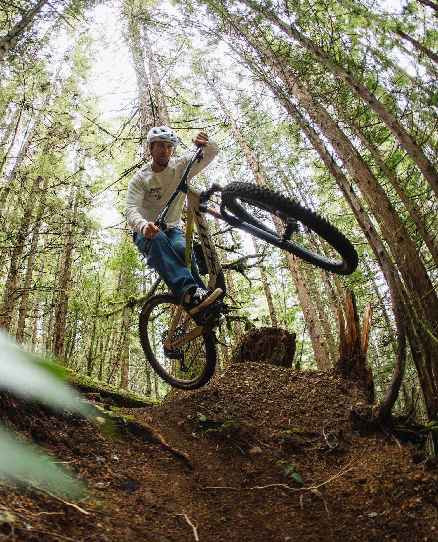 Person riding a mountain bike through a forest