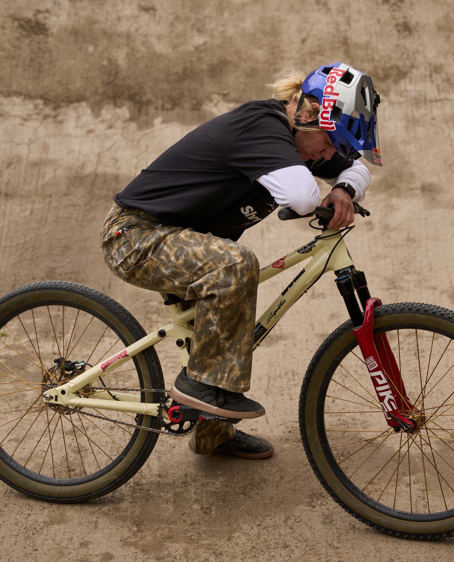 Person riding a bicycle in an urban setting with a helmet on