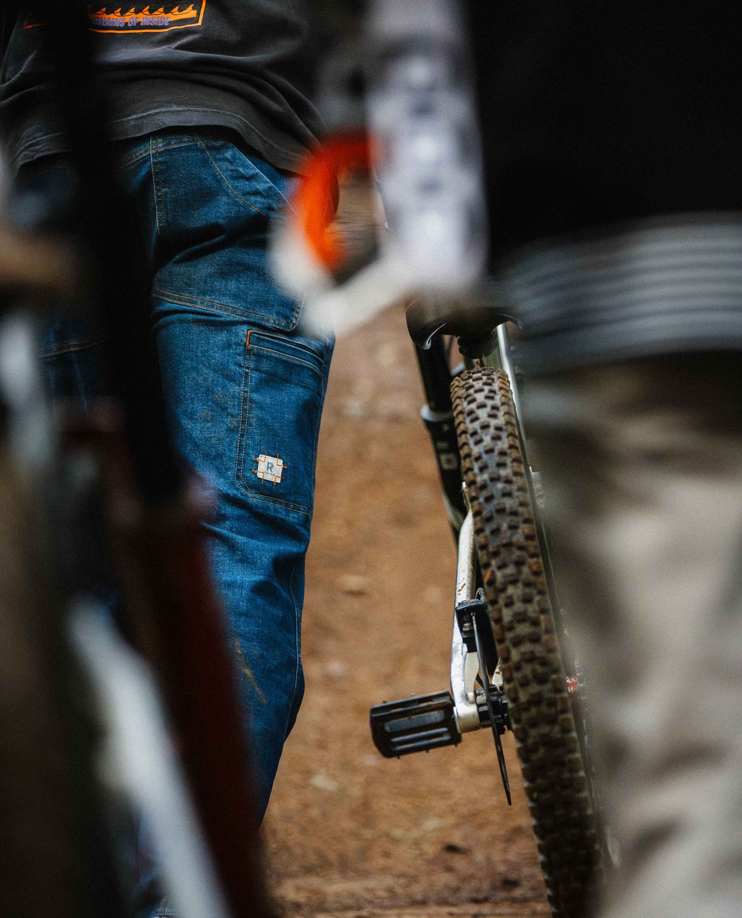Close-up of a mountain bike with focus on the tire and chain, blurred background