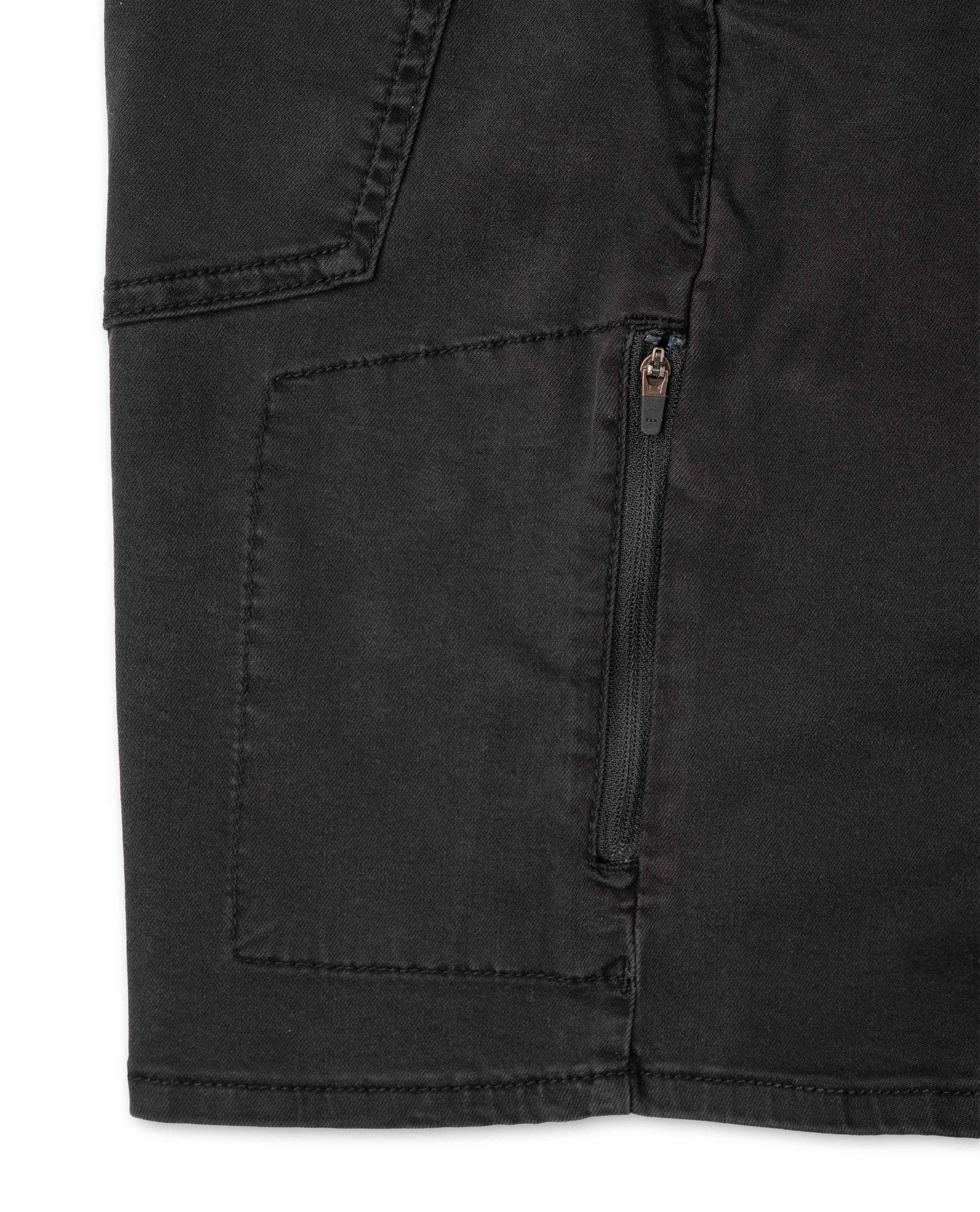 Close up of pocket with zipper on black shorts with white background 