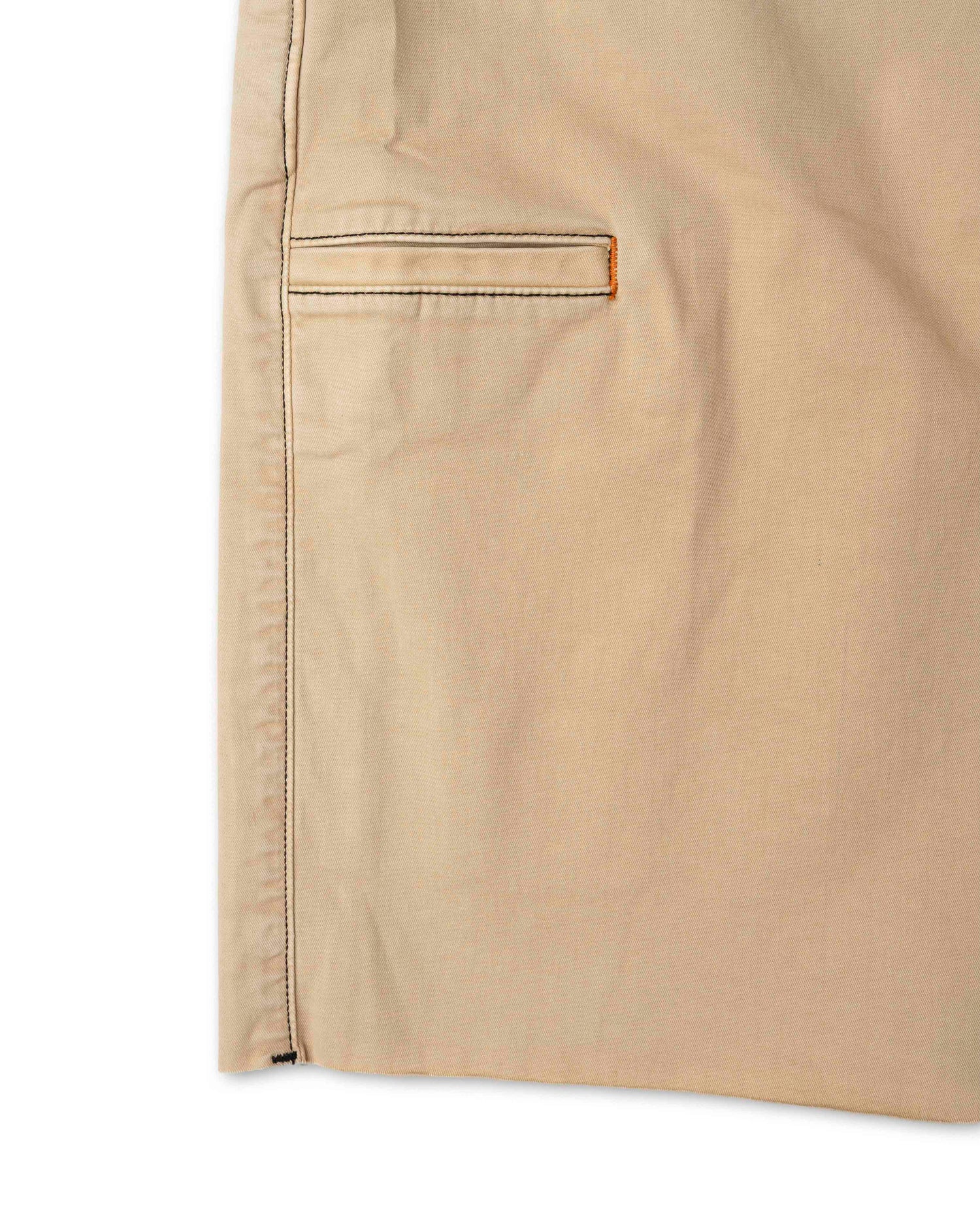 Close-up of beige pants with a pocket on a white background