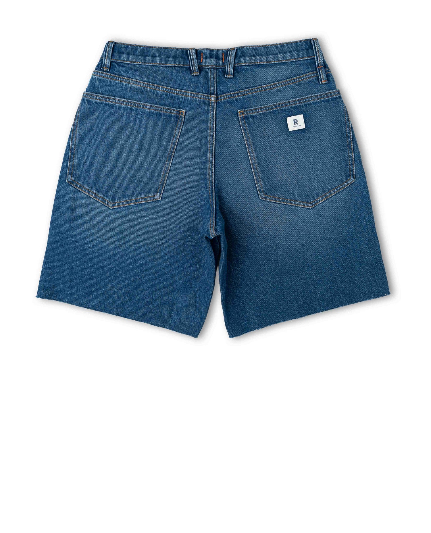 Back of blue denim shorts on white background.