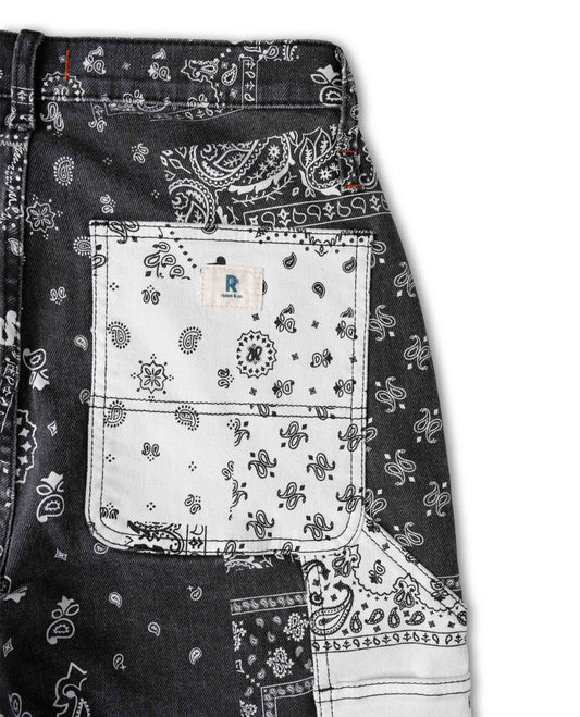 Close up photo of bandana printed pant pocket. The pocket is white, with a white and blue Ripton logo. The background of the photo is white. 