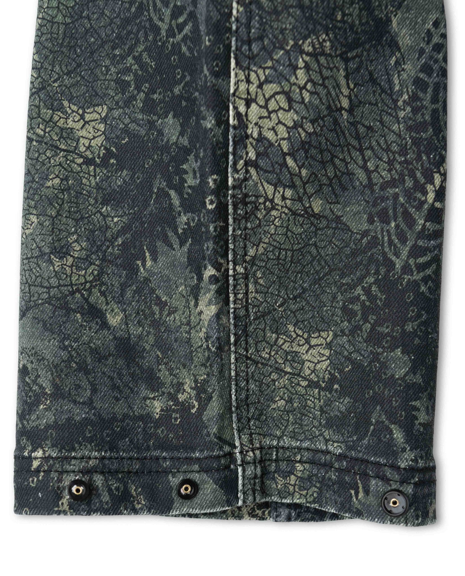 Cuff of camo pant unsnapped showing two-position snap cinch feature