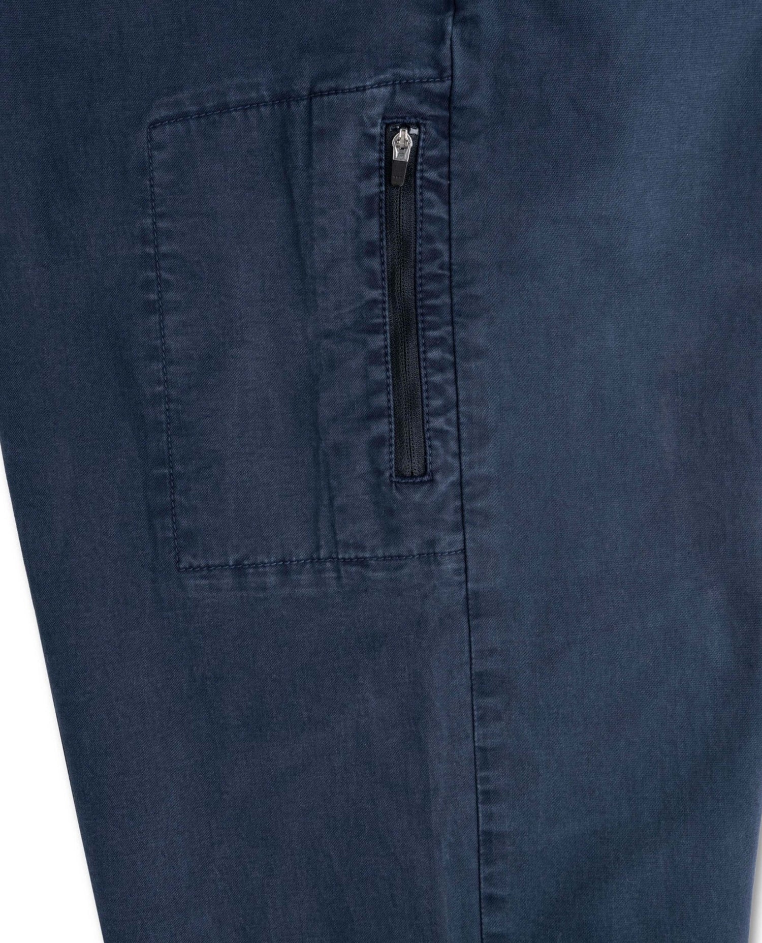 Close-up of a navy blue fabric with a pocket and zipper detail.
