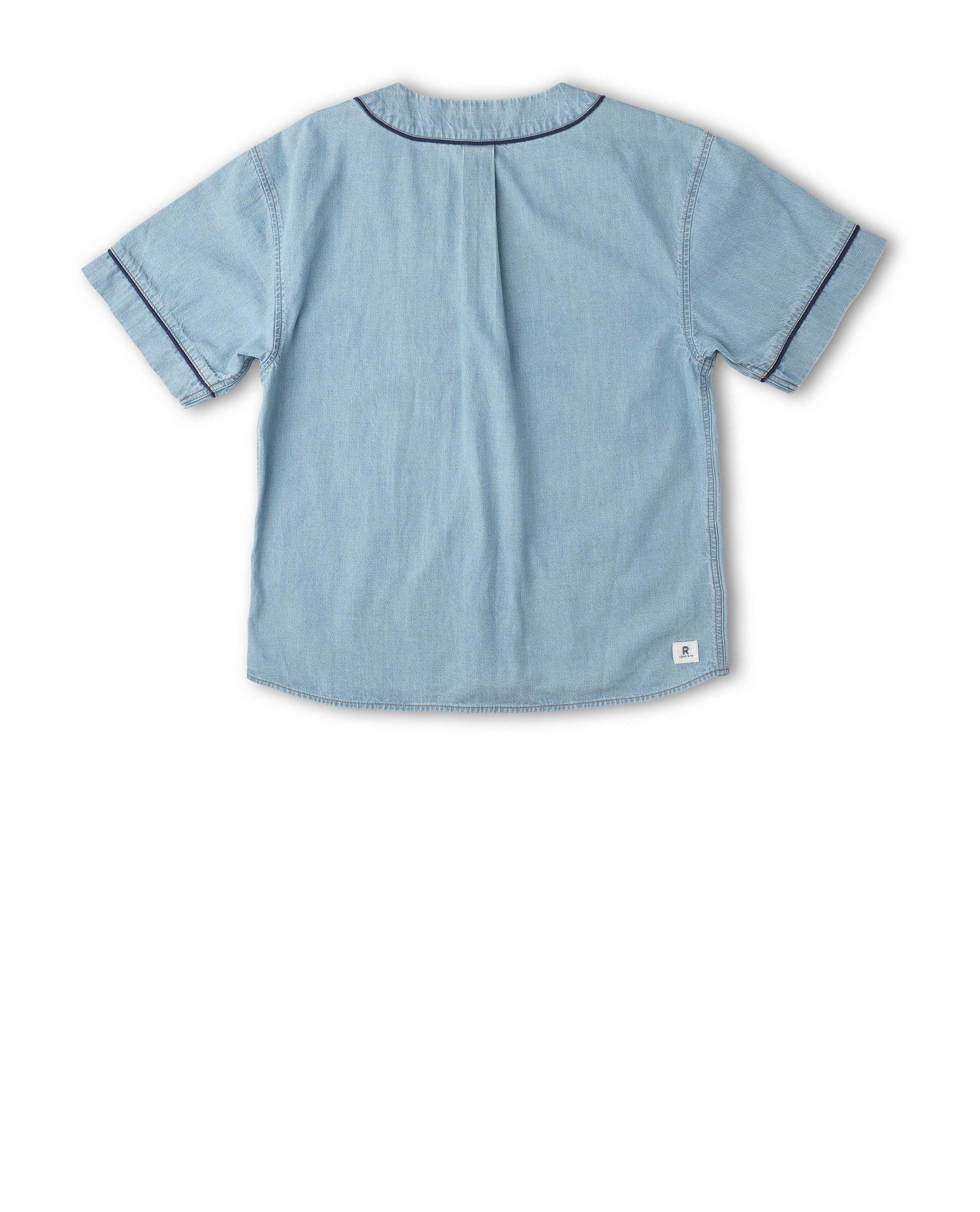 A light blue short-sleeve shirt shown from the back, featuring dark contrast piping along the collar and sleeve cuffs, and a small white brand tag near the bottom right hem.