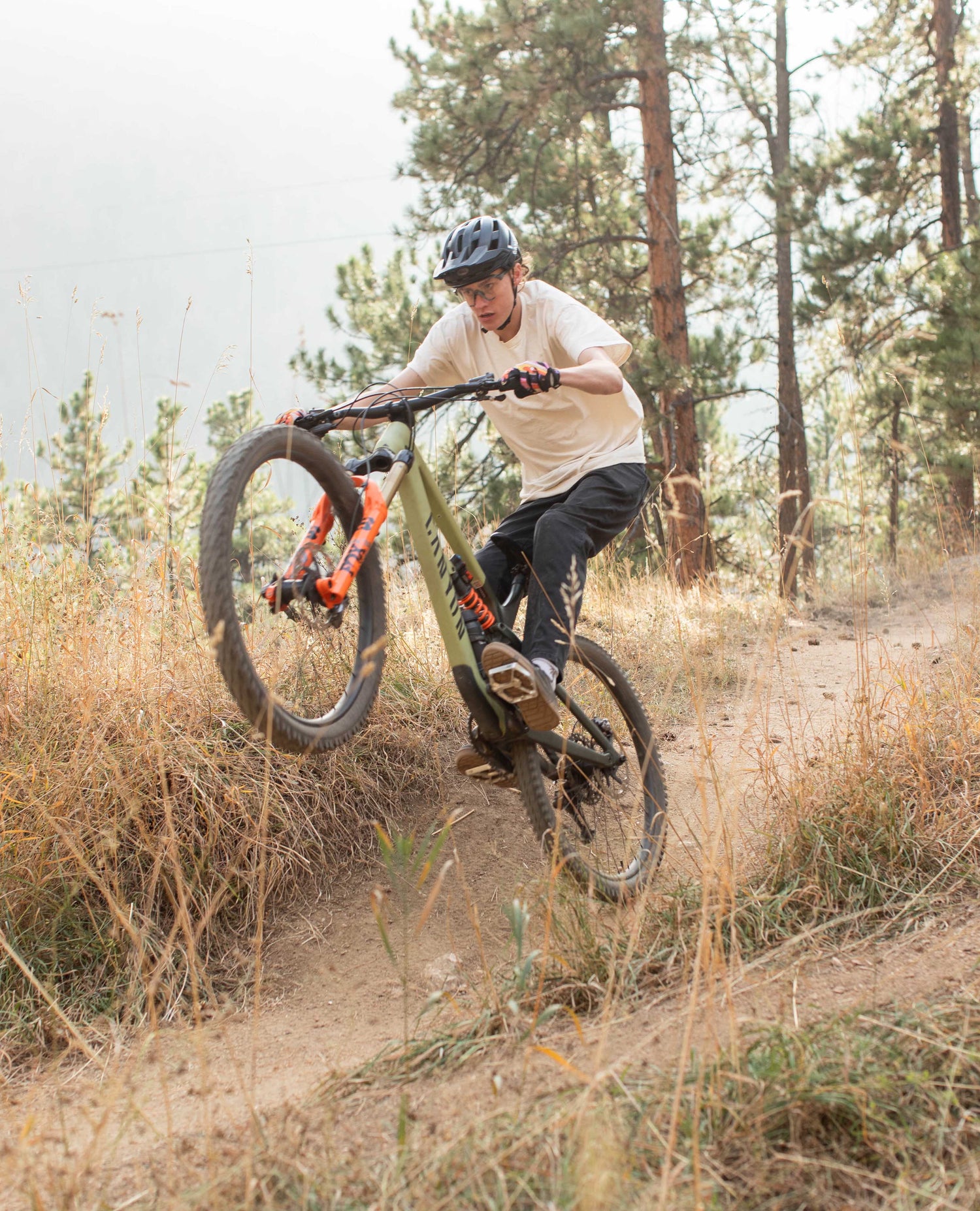 Hadrien doing a wheelie in Superlite jeans