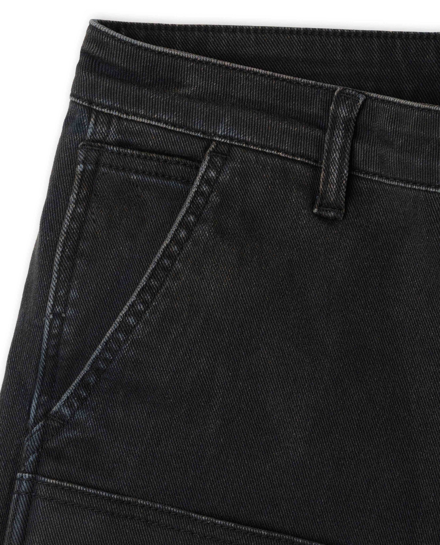 Close up of waistband and pockets of black pants on white background