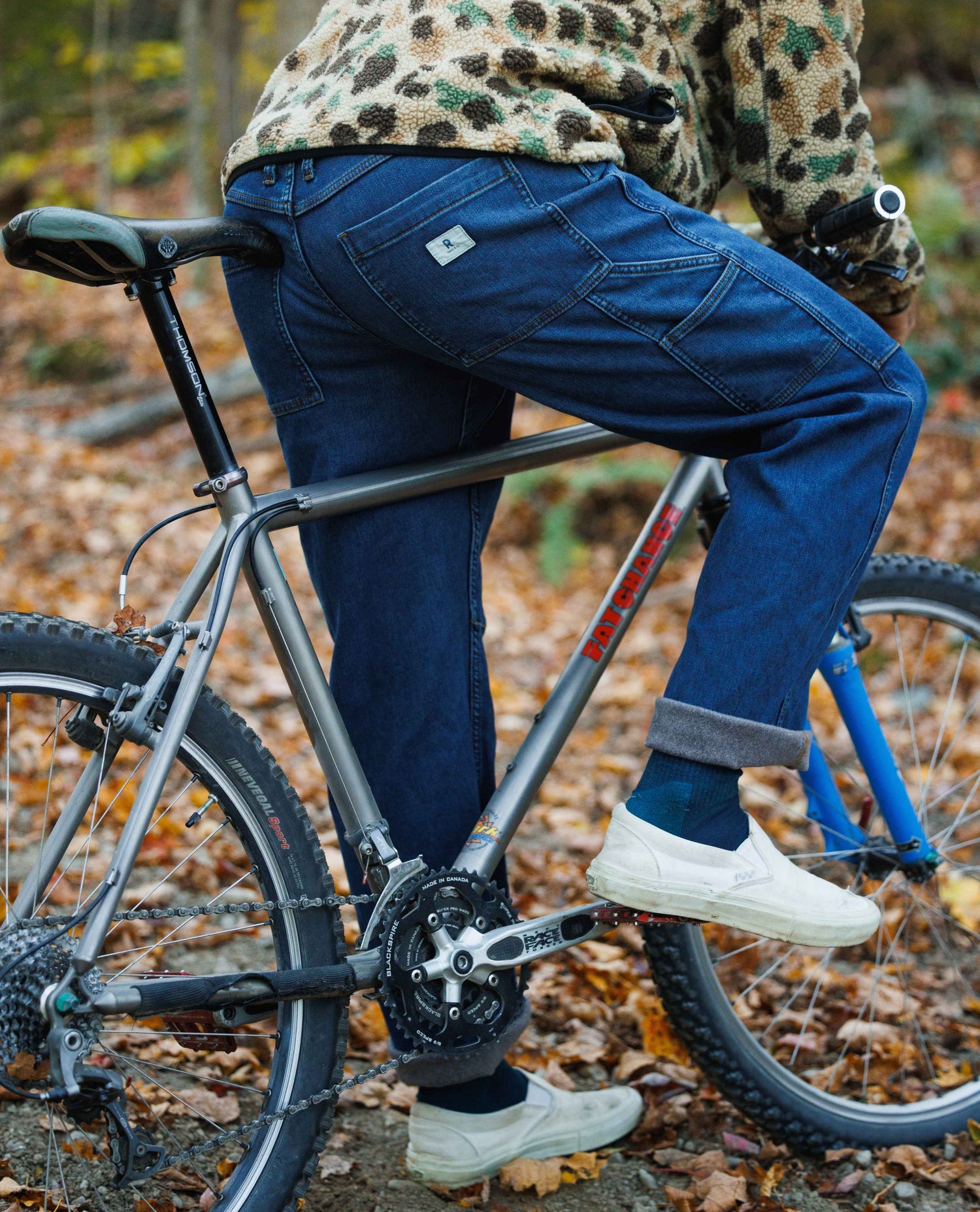Person riding a bicycle in a forest setting