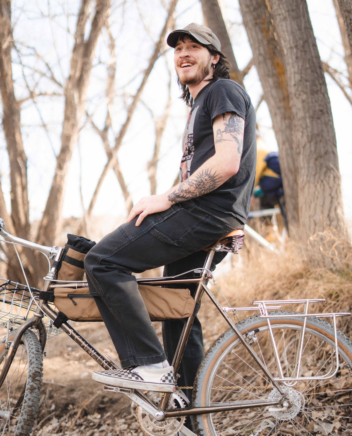 Max sitting on his bike in black pants