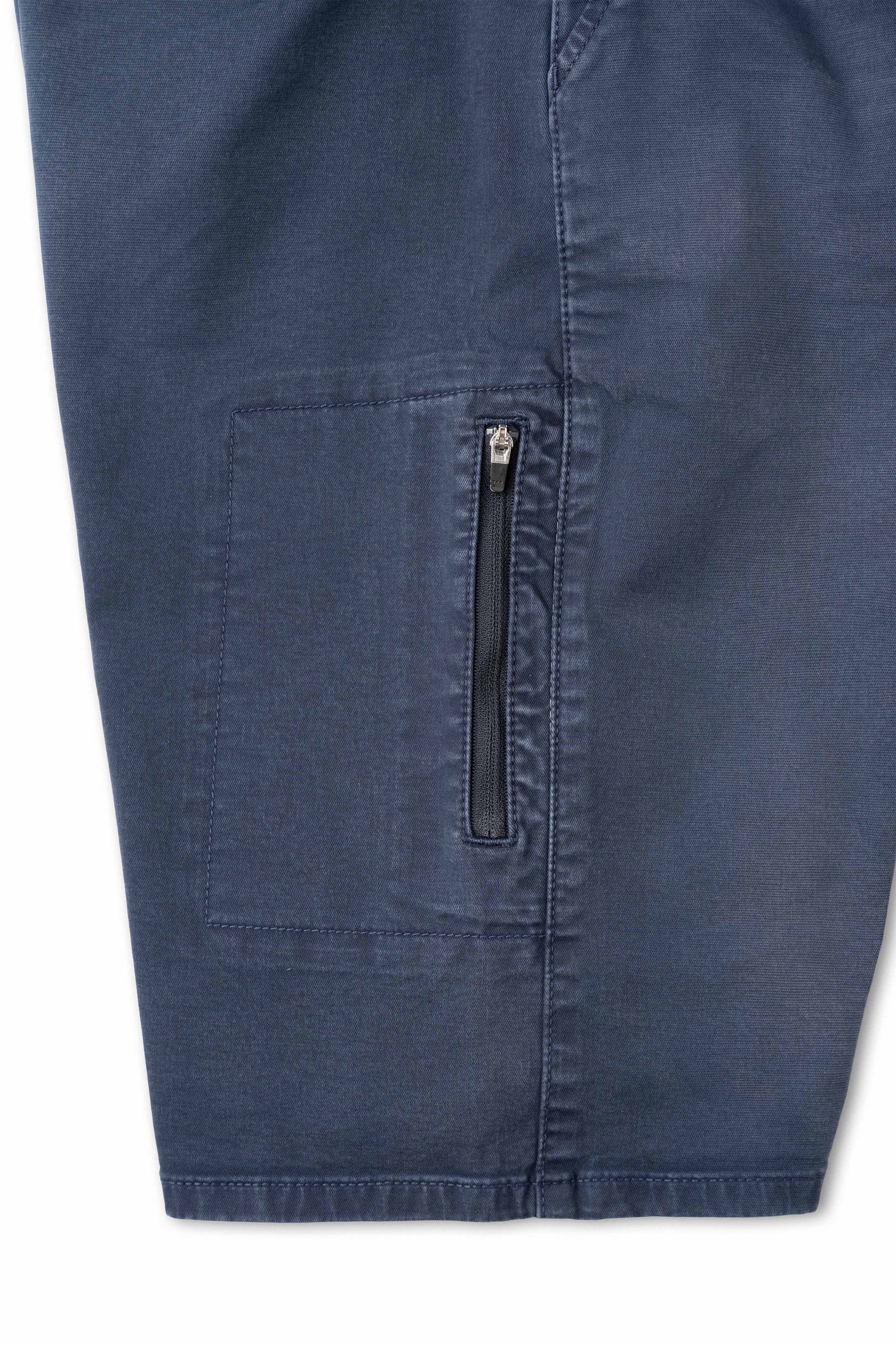 Close-up of a blue denim pocket with a zipper on a white background