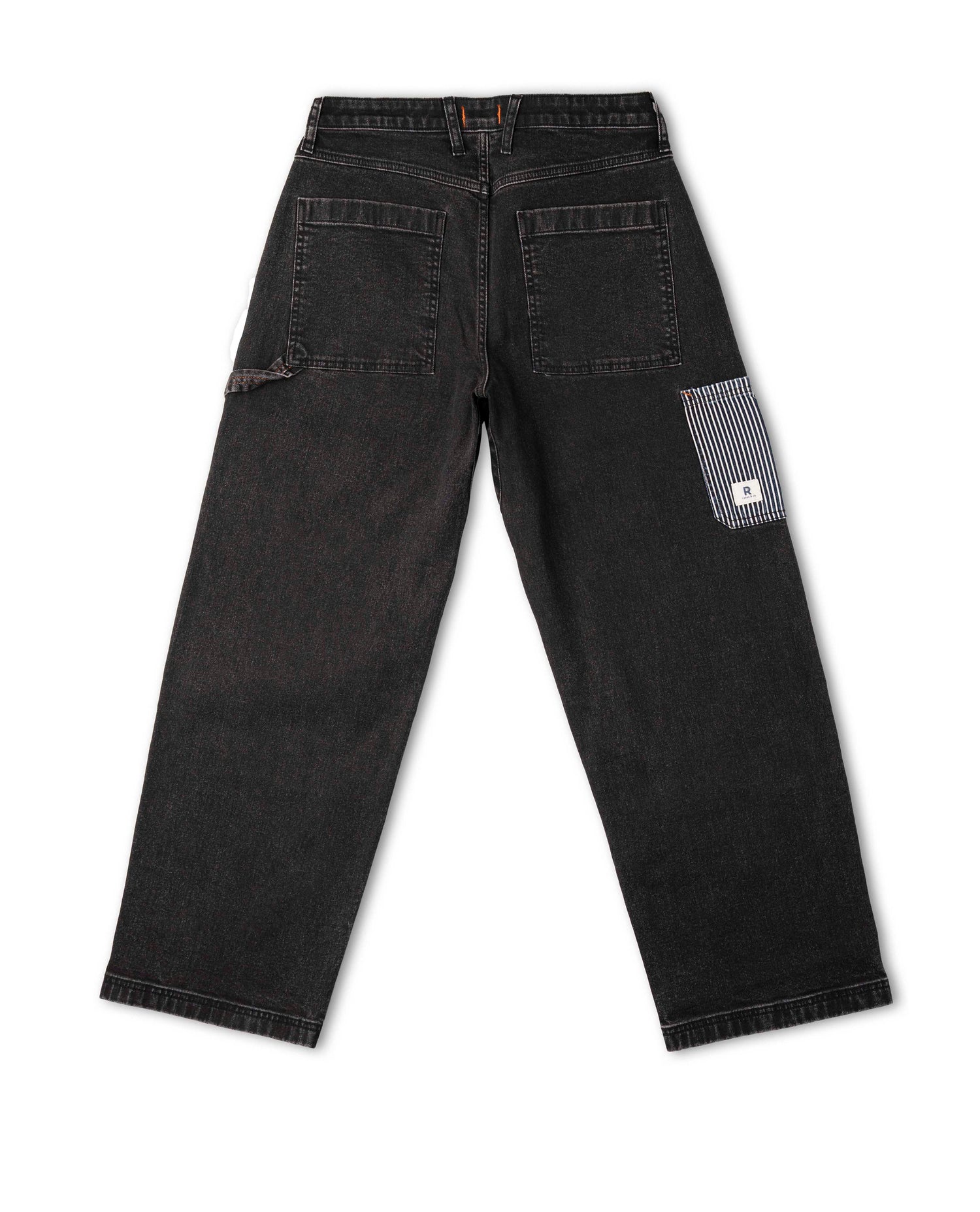 Black denim pants with a visible brand logo on a white background