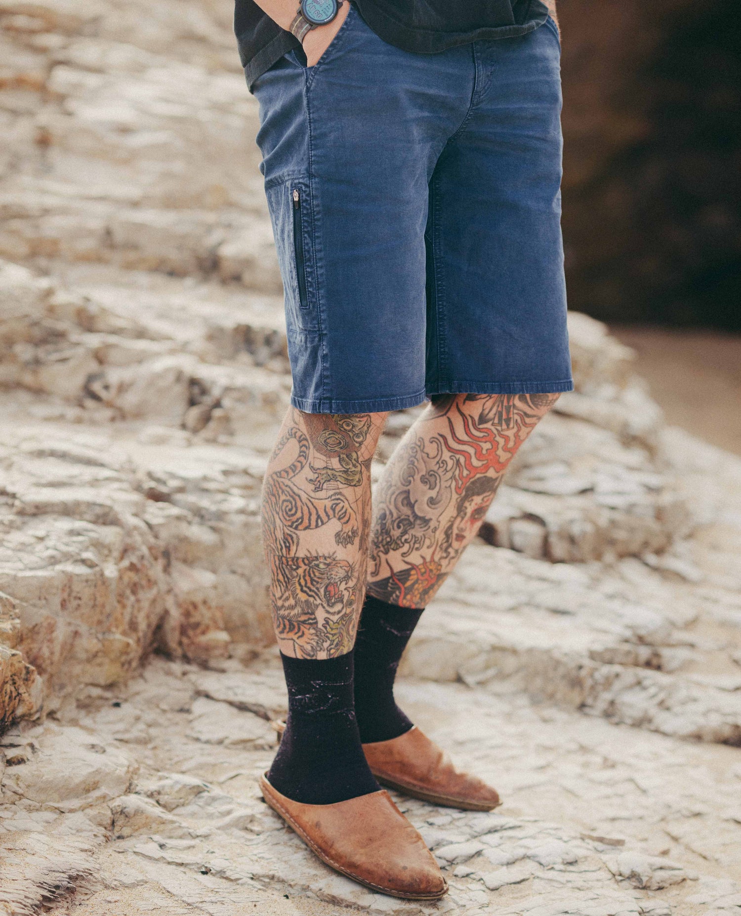 Close up of reggie shorts on tattooed legs