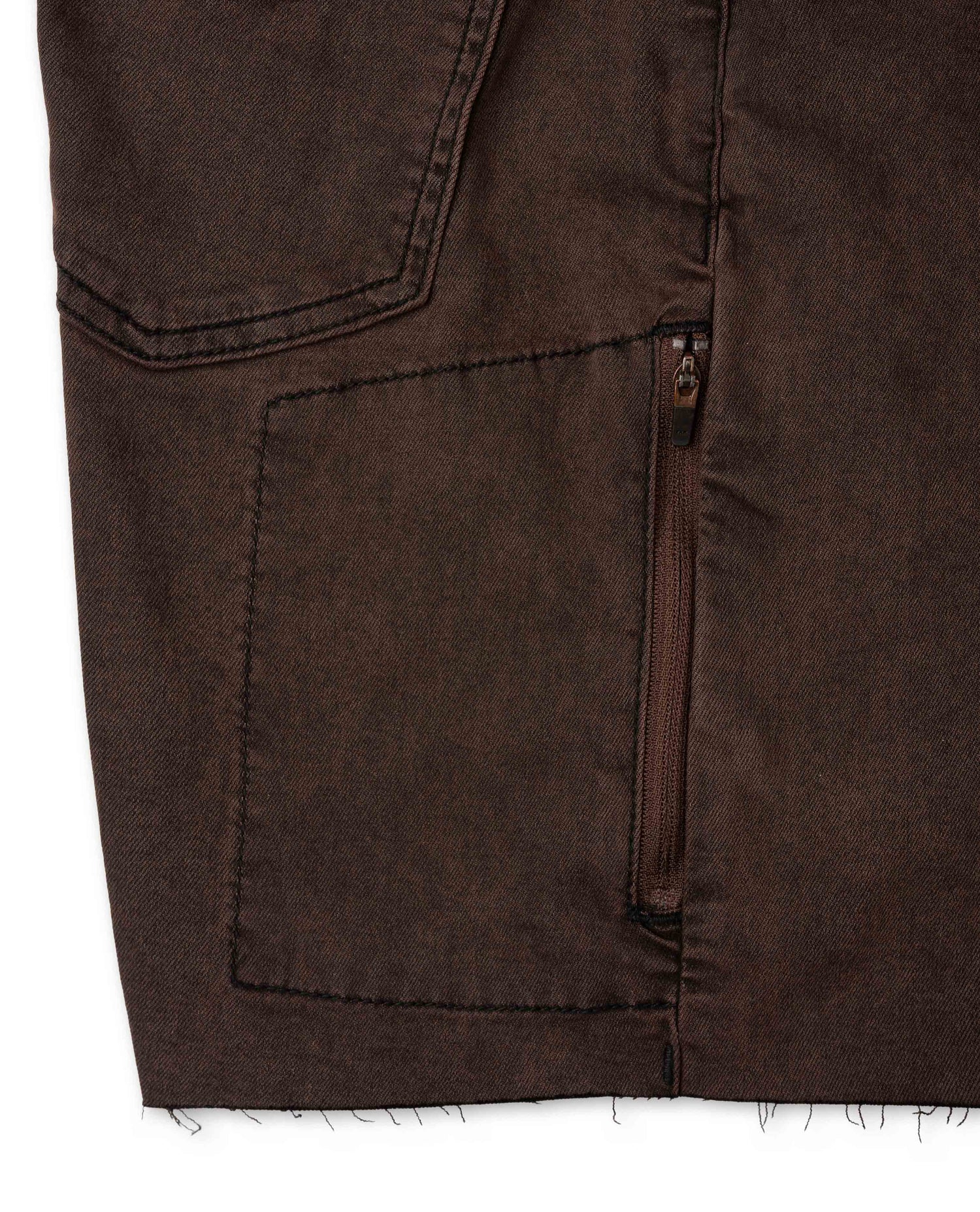 Close-up of a brown jacket with a pocket and zipper detail on a white background