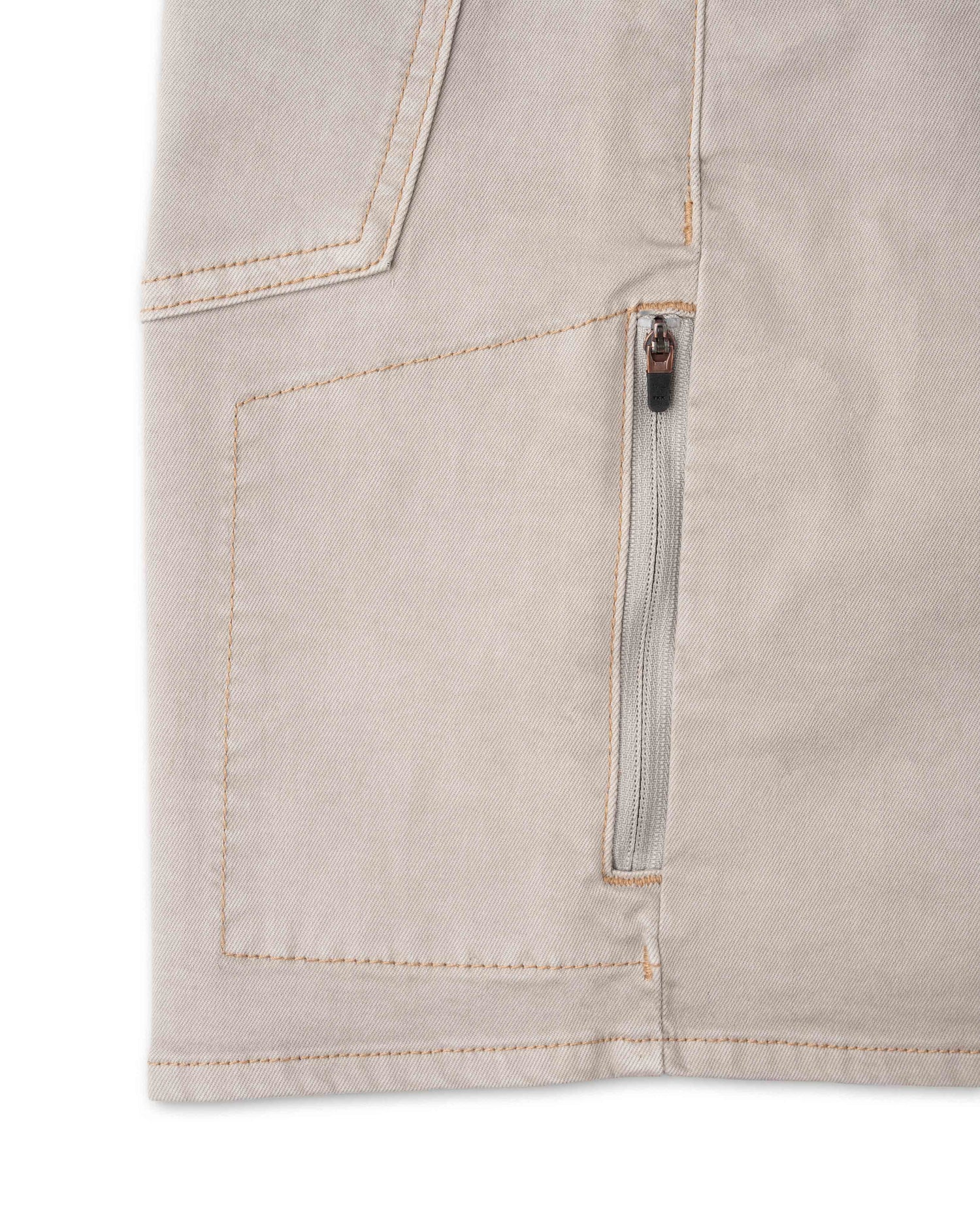 Close-up of a beige pocket with a zipper on a white background