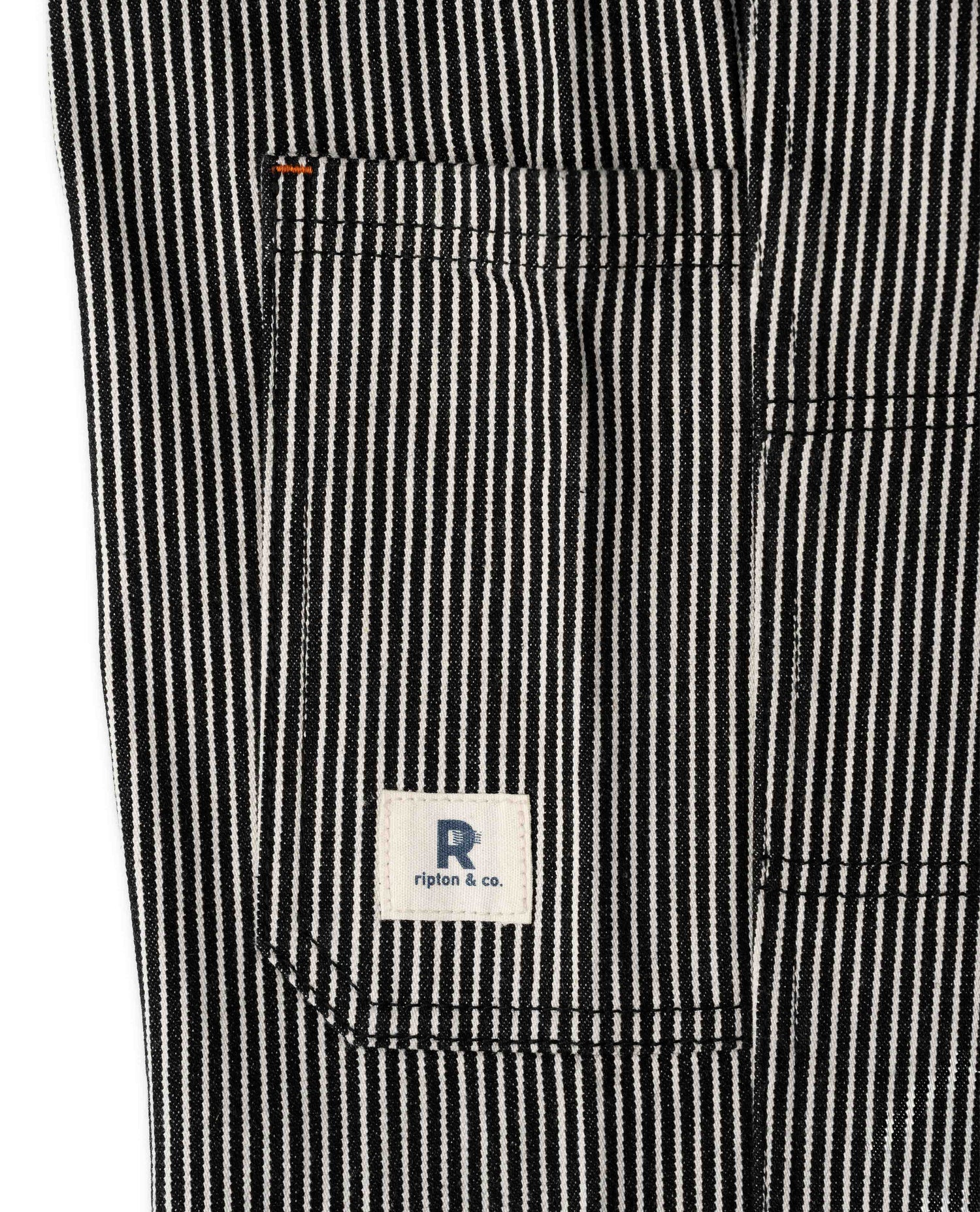Black and white striped pant, close up of pocket, with Ripton logo, sideview, on white background