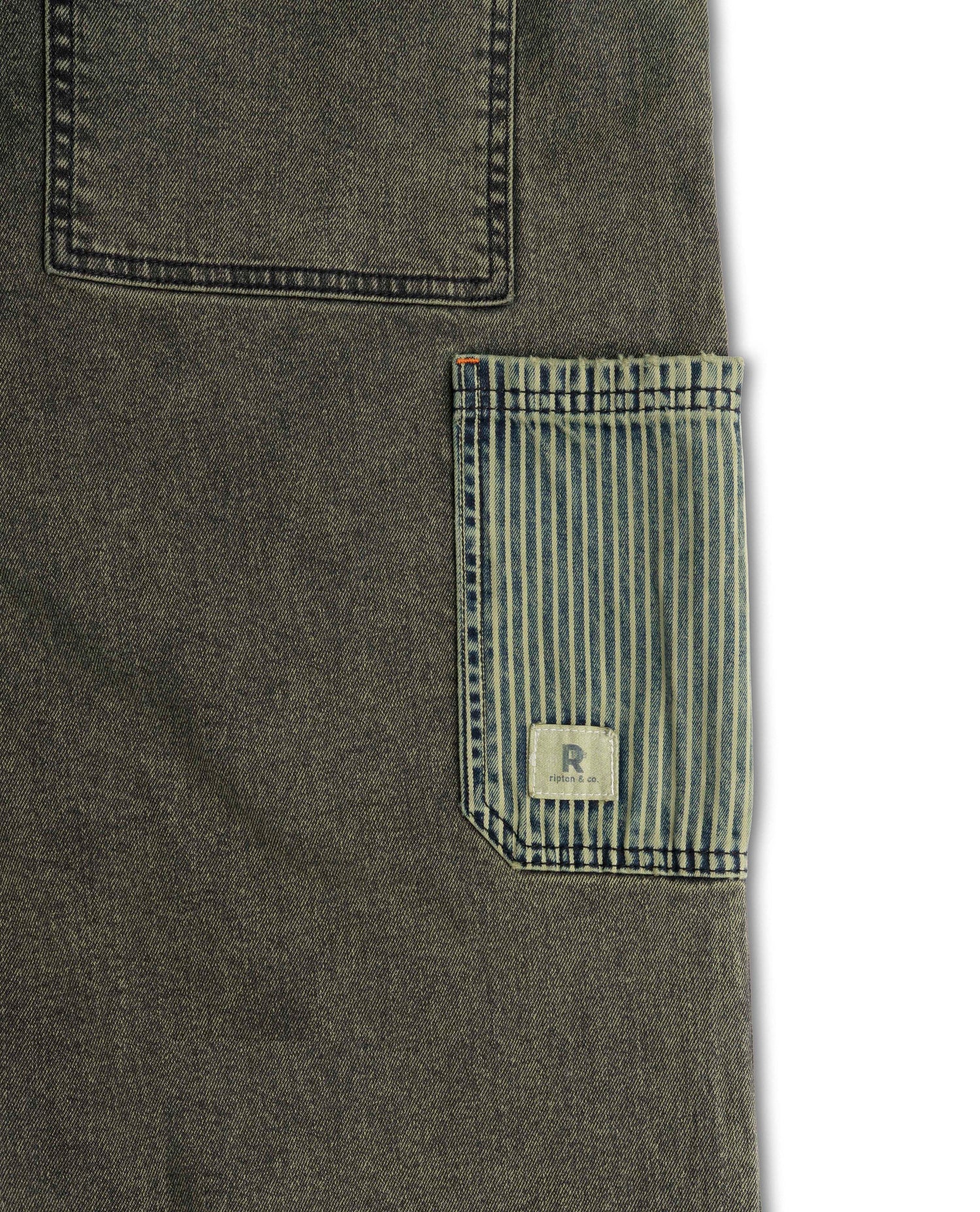 Close-up of a dark green denim pocket with a striped patch and brand logo on a white background