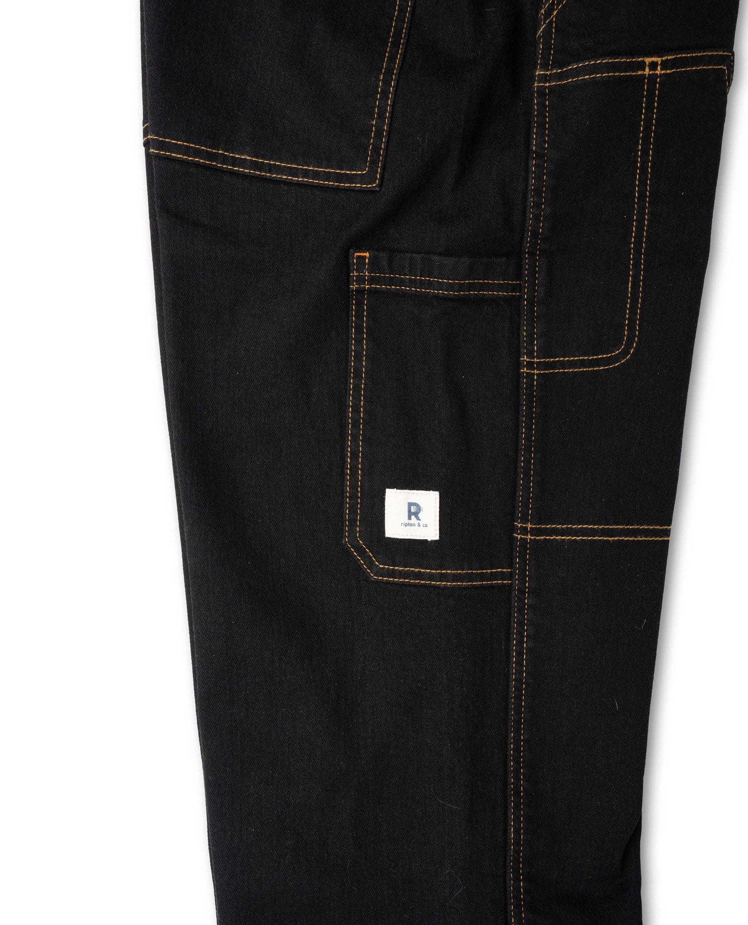 Side detail of pocket, black pant with yellow stitching, white Ripton logo 