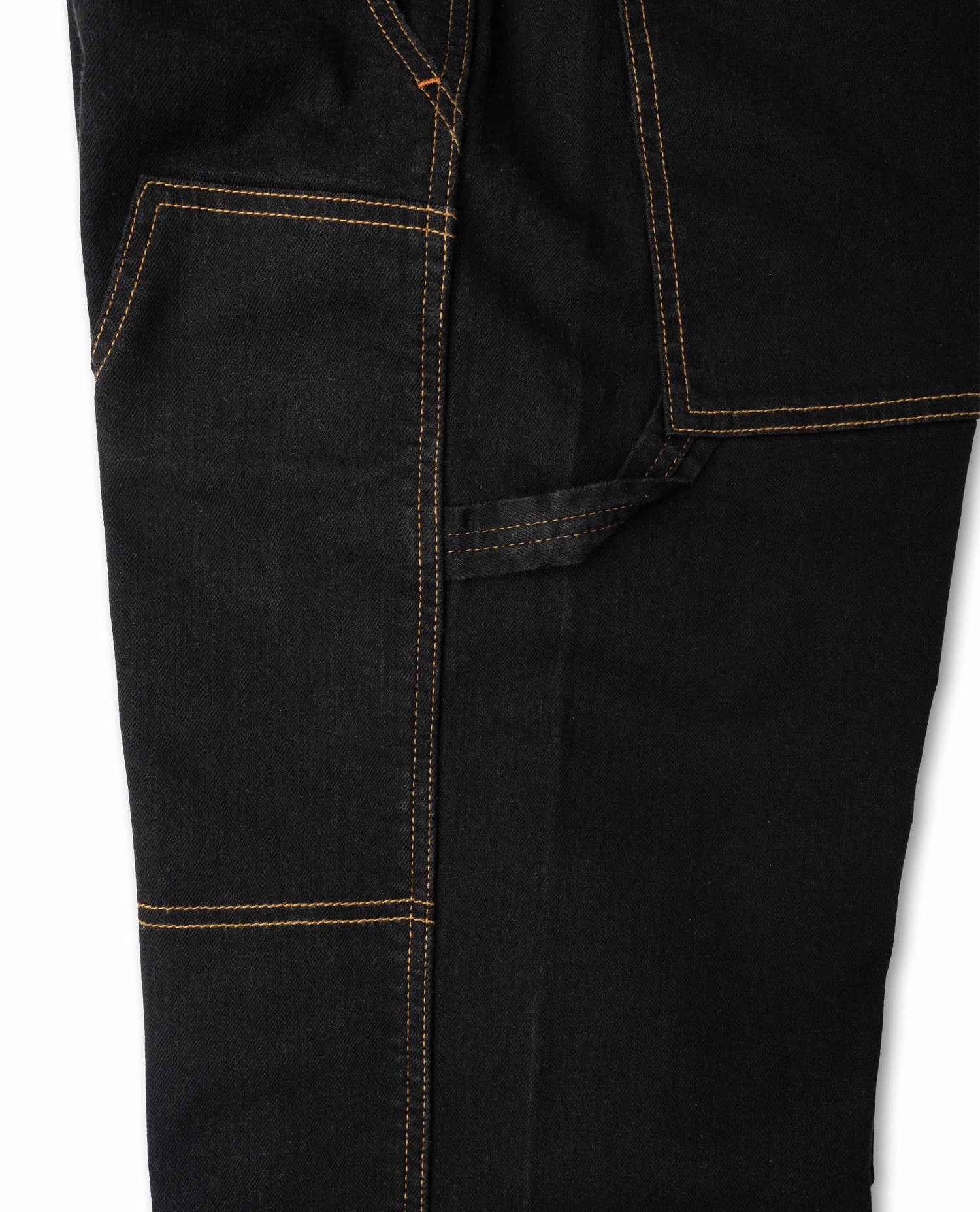 Side detail photo of hammer loop on black pant with yellow stitching on white background