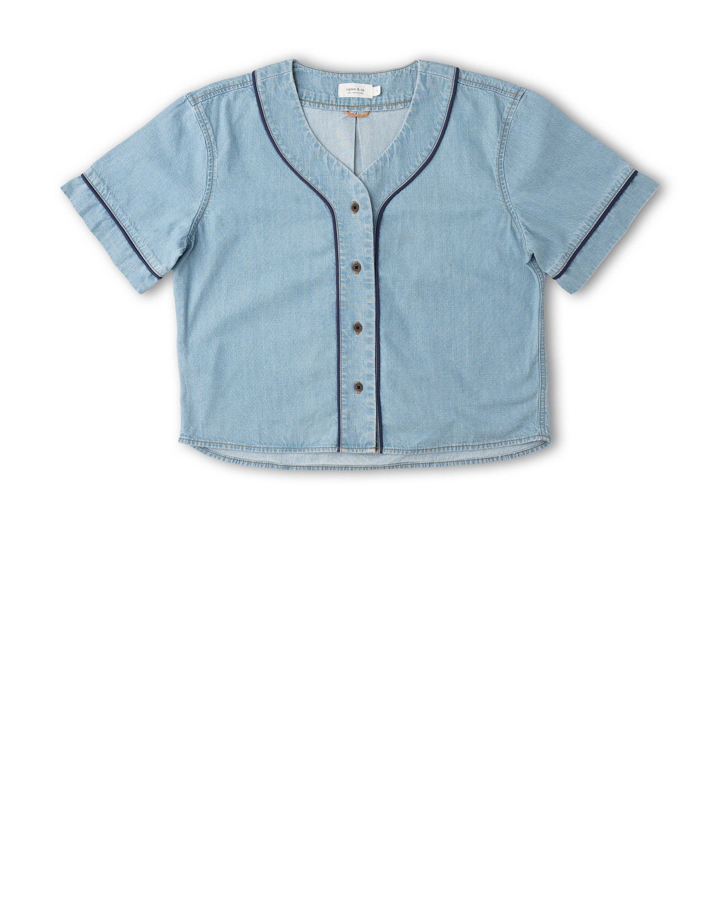 A light blue denim short-sleeve button-up shirt with dark contrast piping along the V-neck, cuffs, and front placket, displayed flat against a white background.