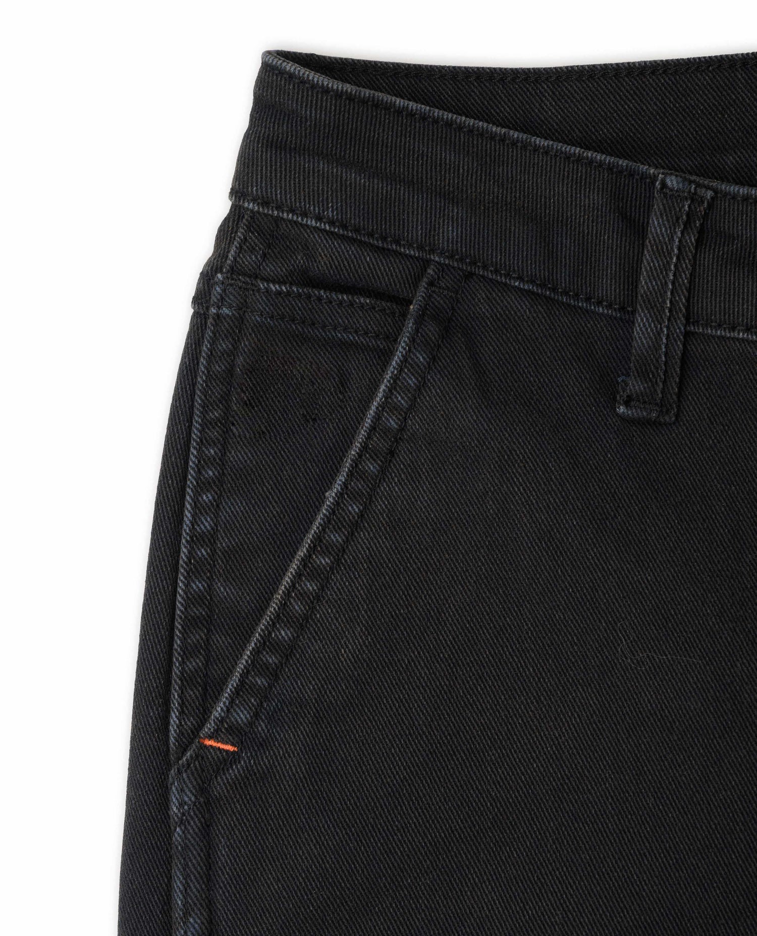 Close-up of black jeans with a white background