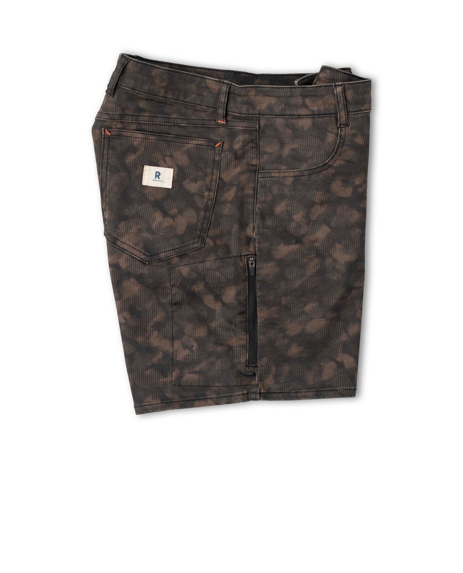 Dark camouflage pants with a brand label on a white background