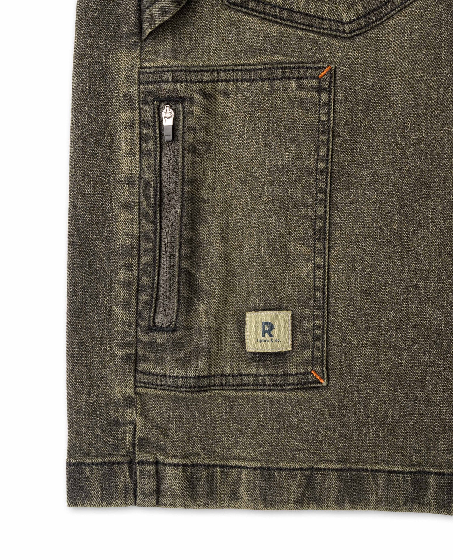 Close-up of a green denim jacket with a zipper pocket and brand logo on a white background