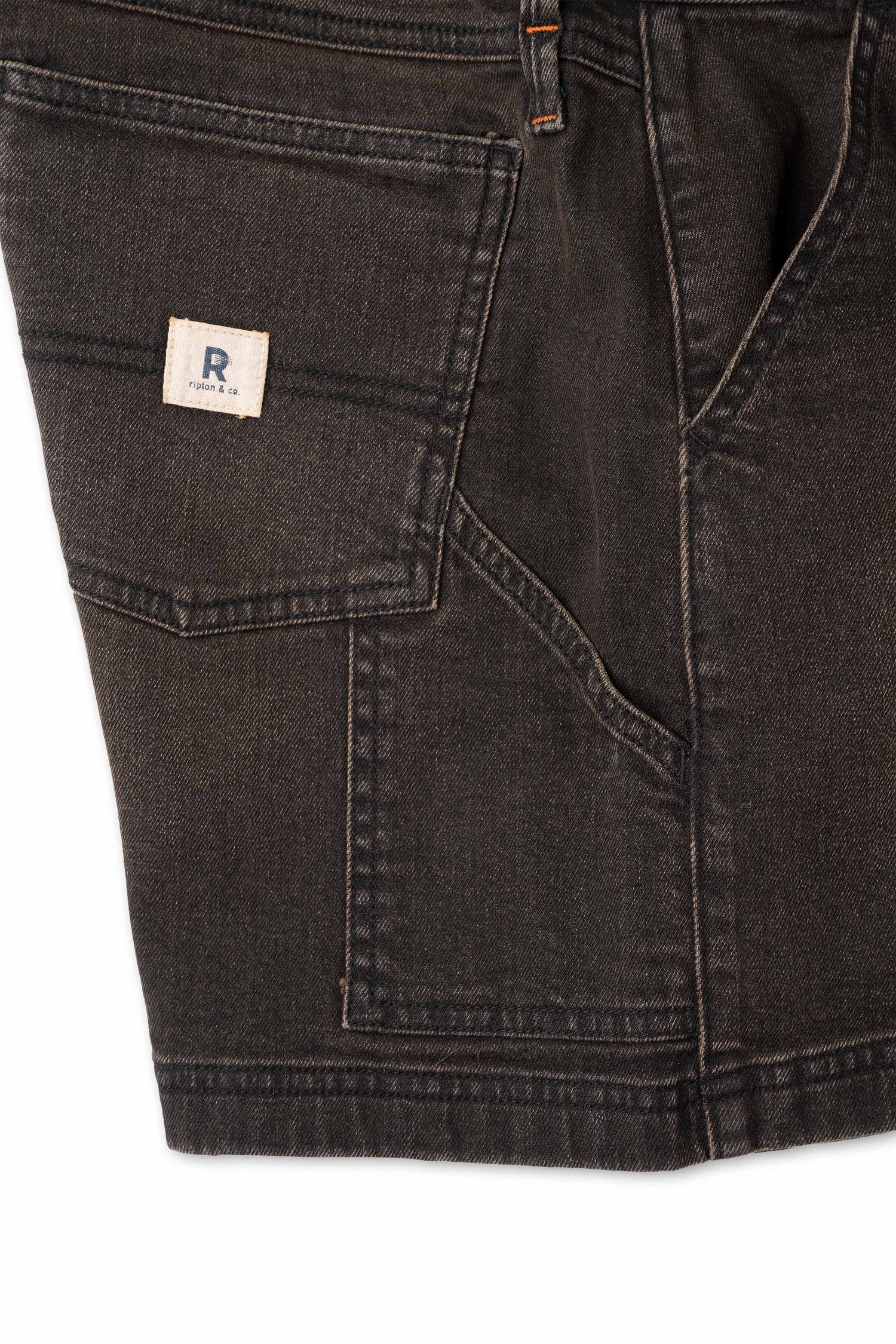 Close up of side pocket on dark brown shorts with white background 