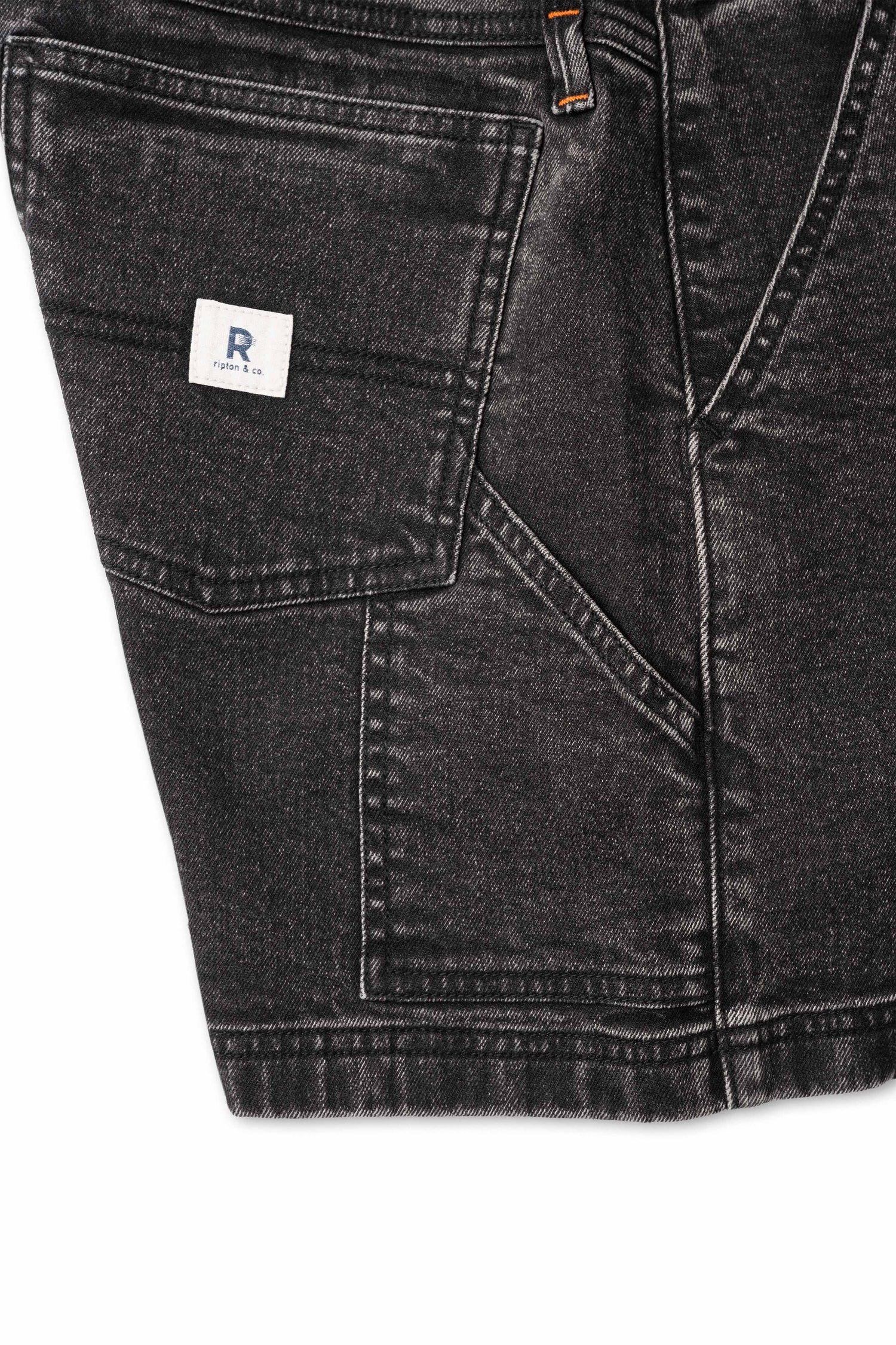 Close up of side pocket on black shorts with white background