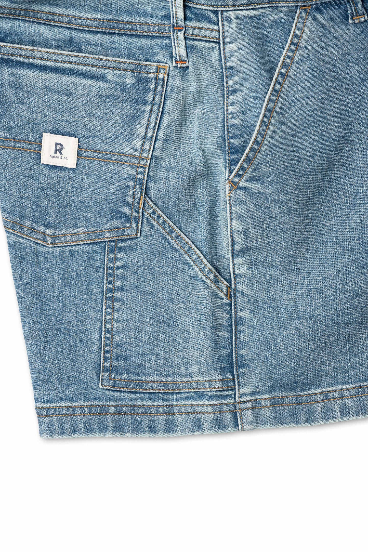 Close up of pocket on blue shorts with white background