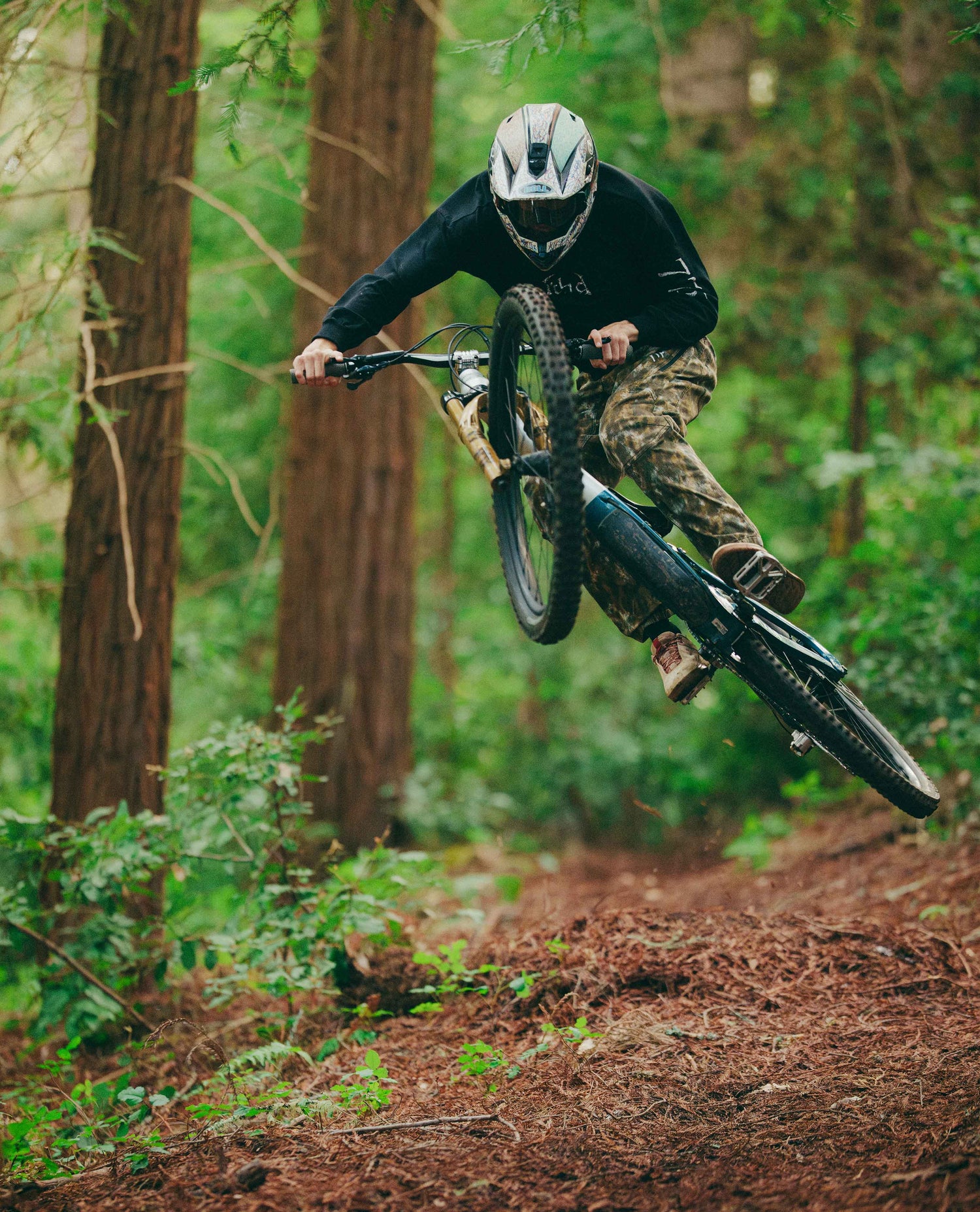 Person riding a mountain bike through a forest