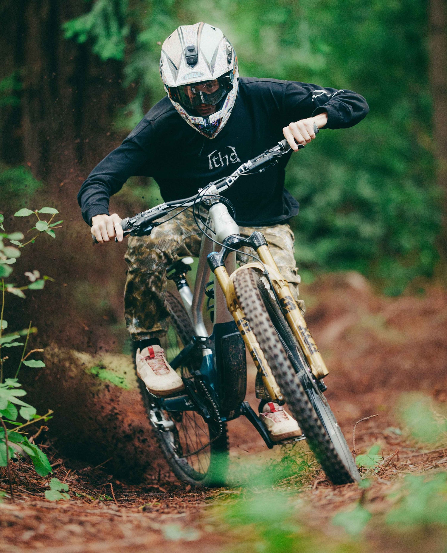 Person riding a mountain bike through a forest