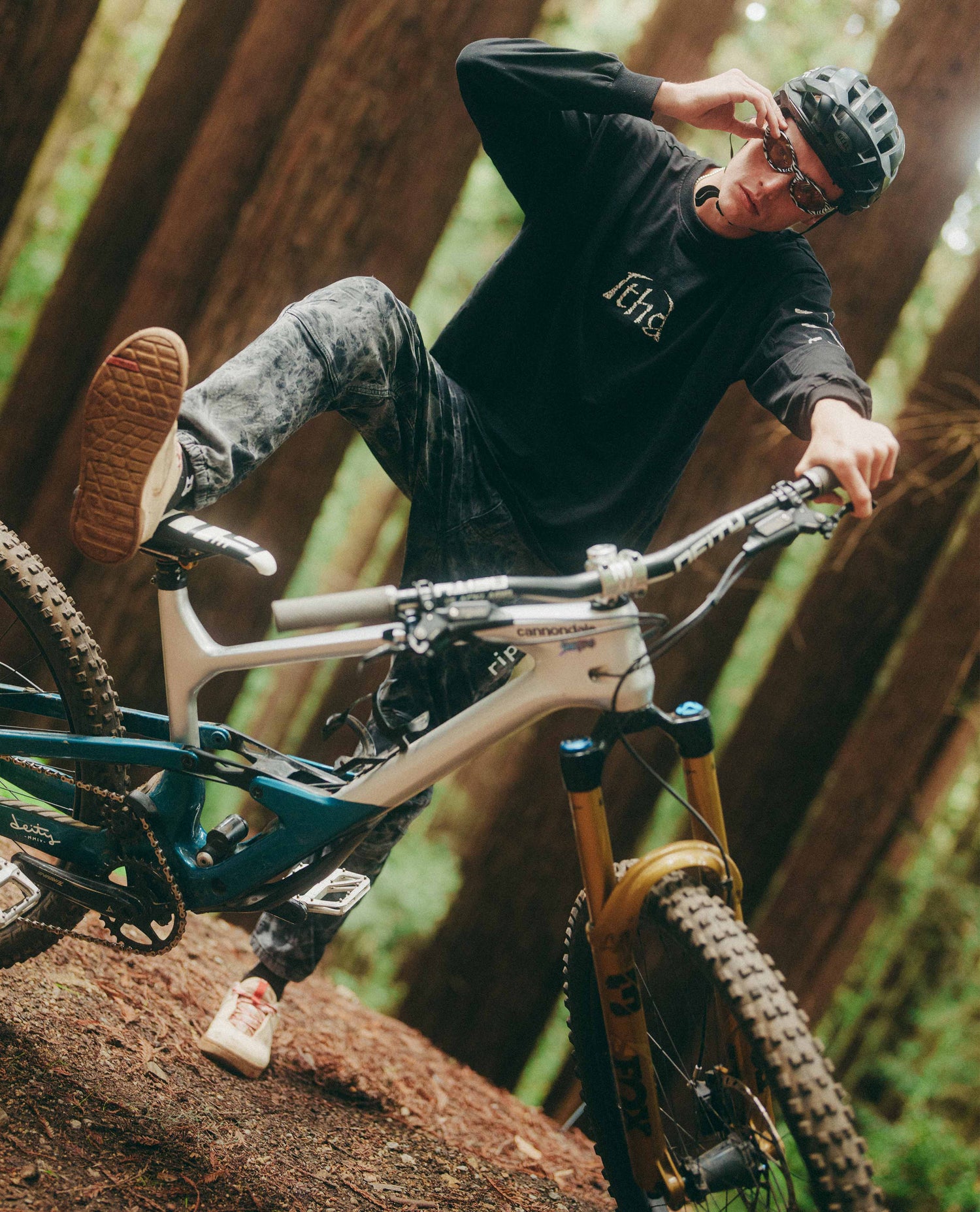 Person riding a mountain bike on a rocky trail in a forest