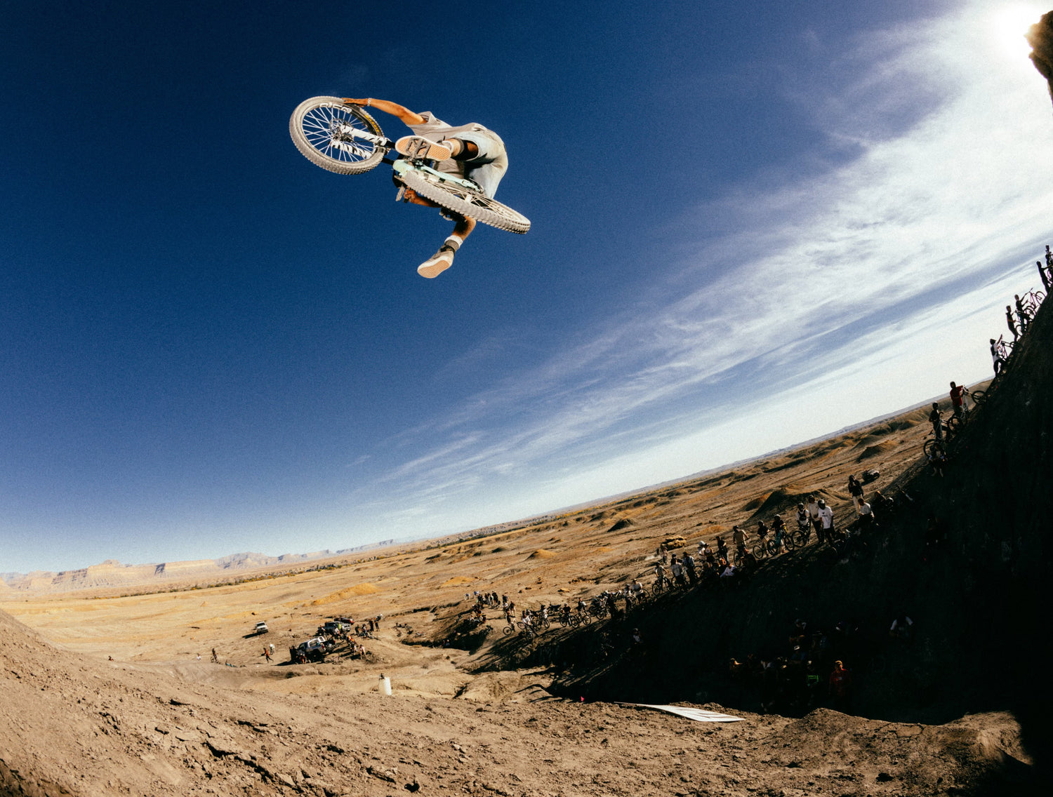 Person on a dirt bike performing a jump against a blue sky