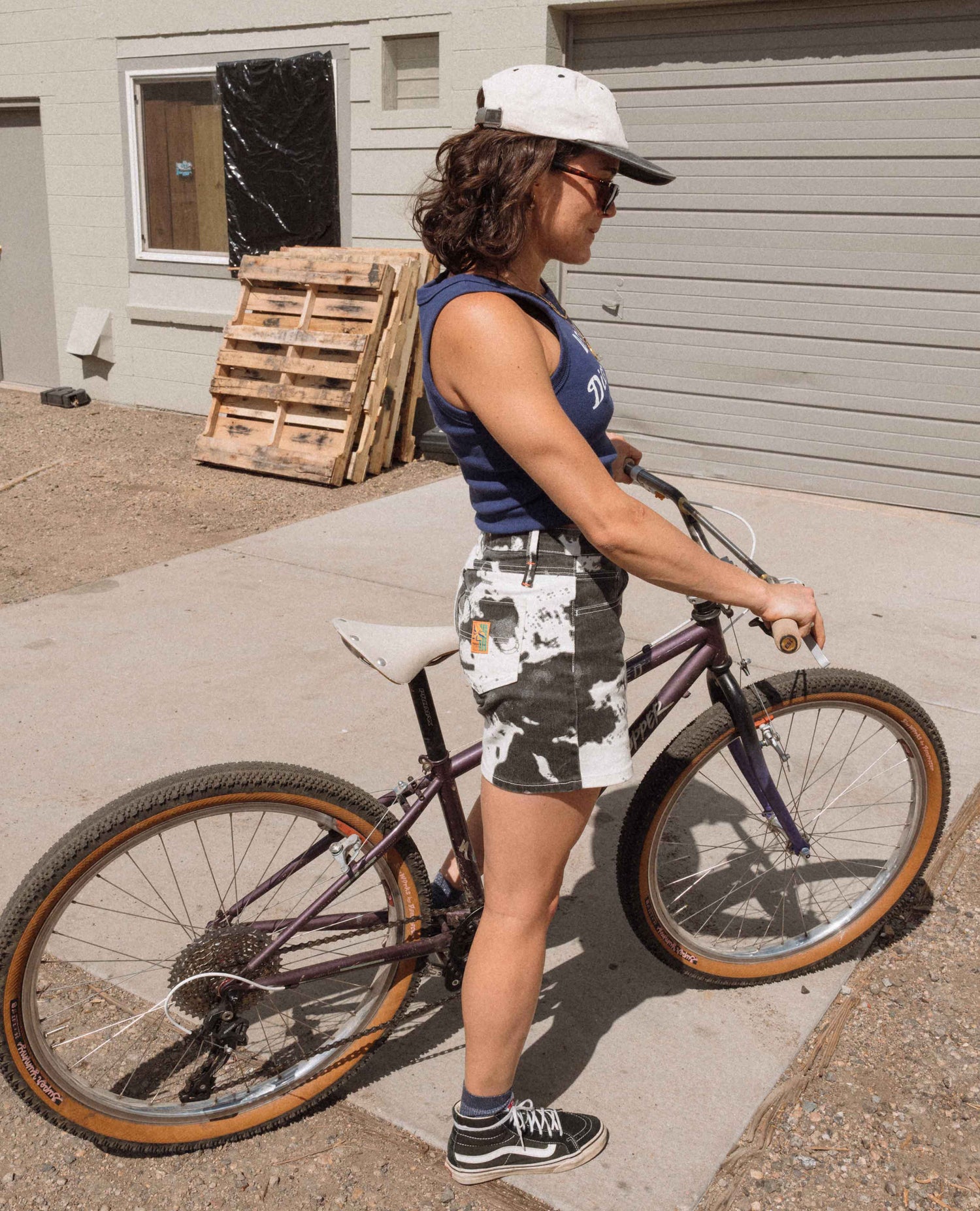 Person with a bicycle in an outdoor setting