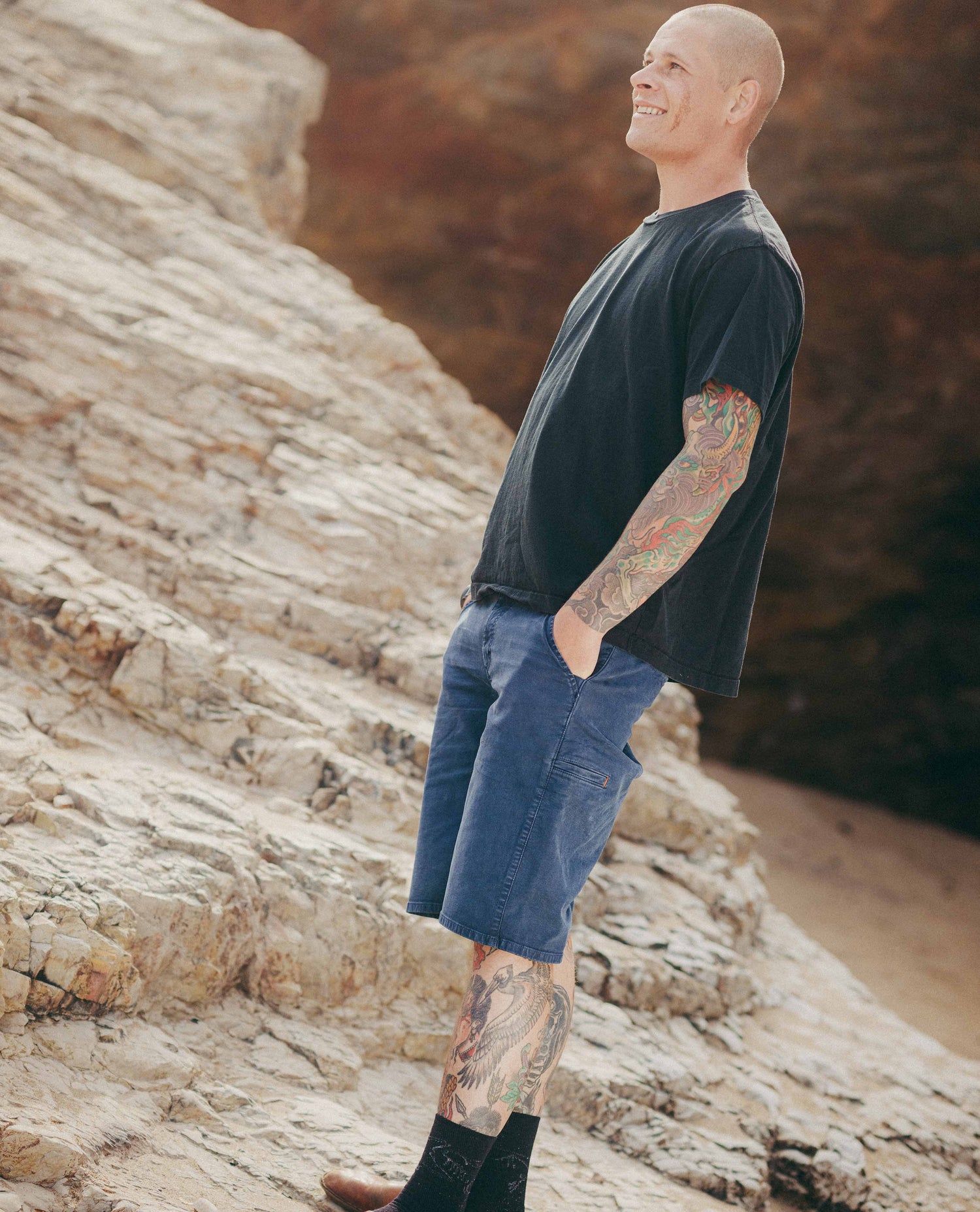 Cool guy with tattoos wearing blue reggie shorts