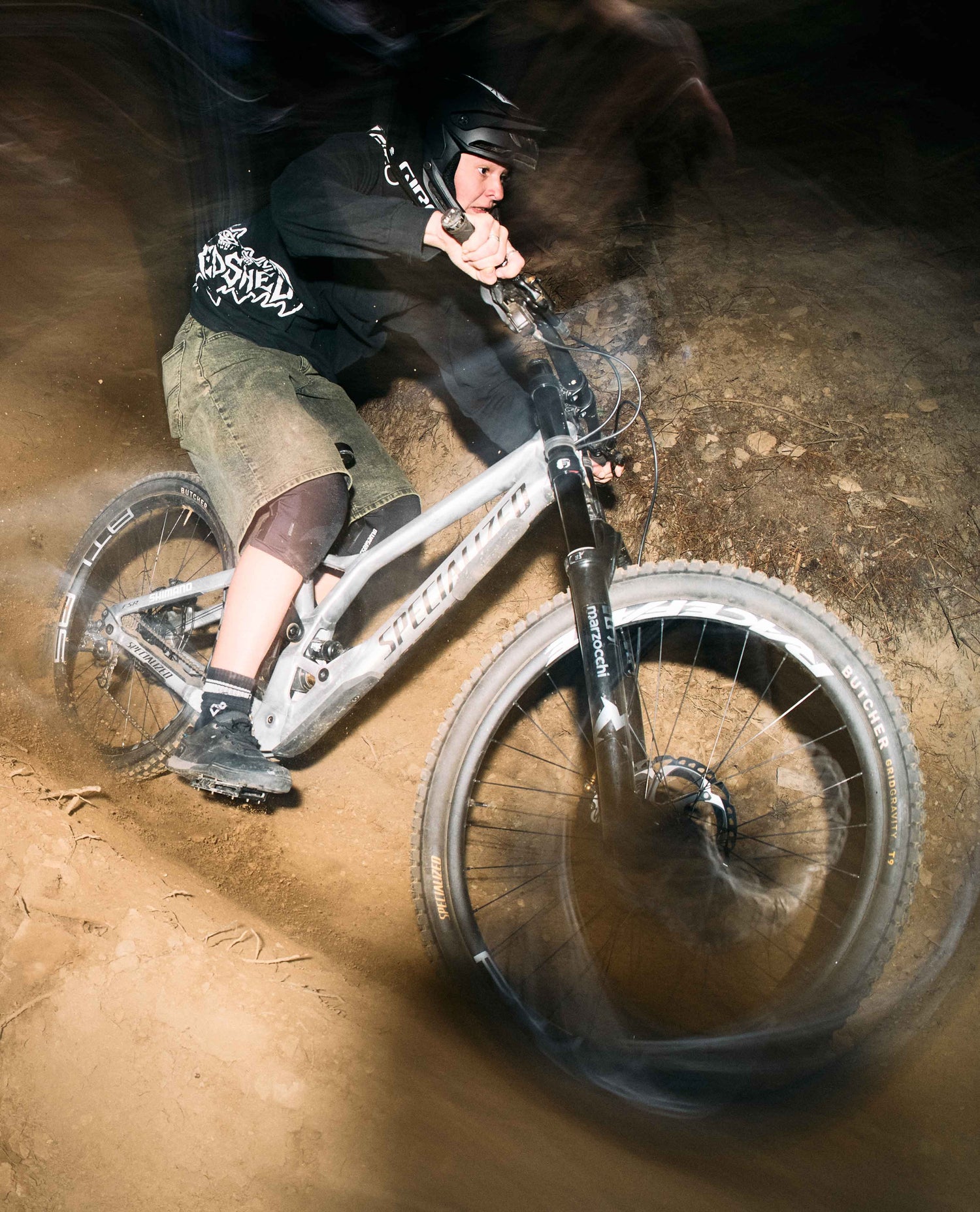 Person riding a mountain bike on a dirt trail with motion blur effect