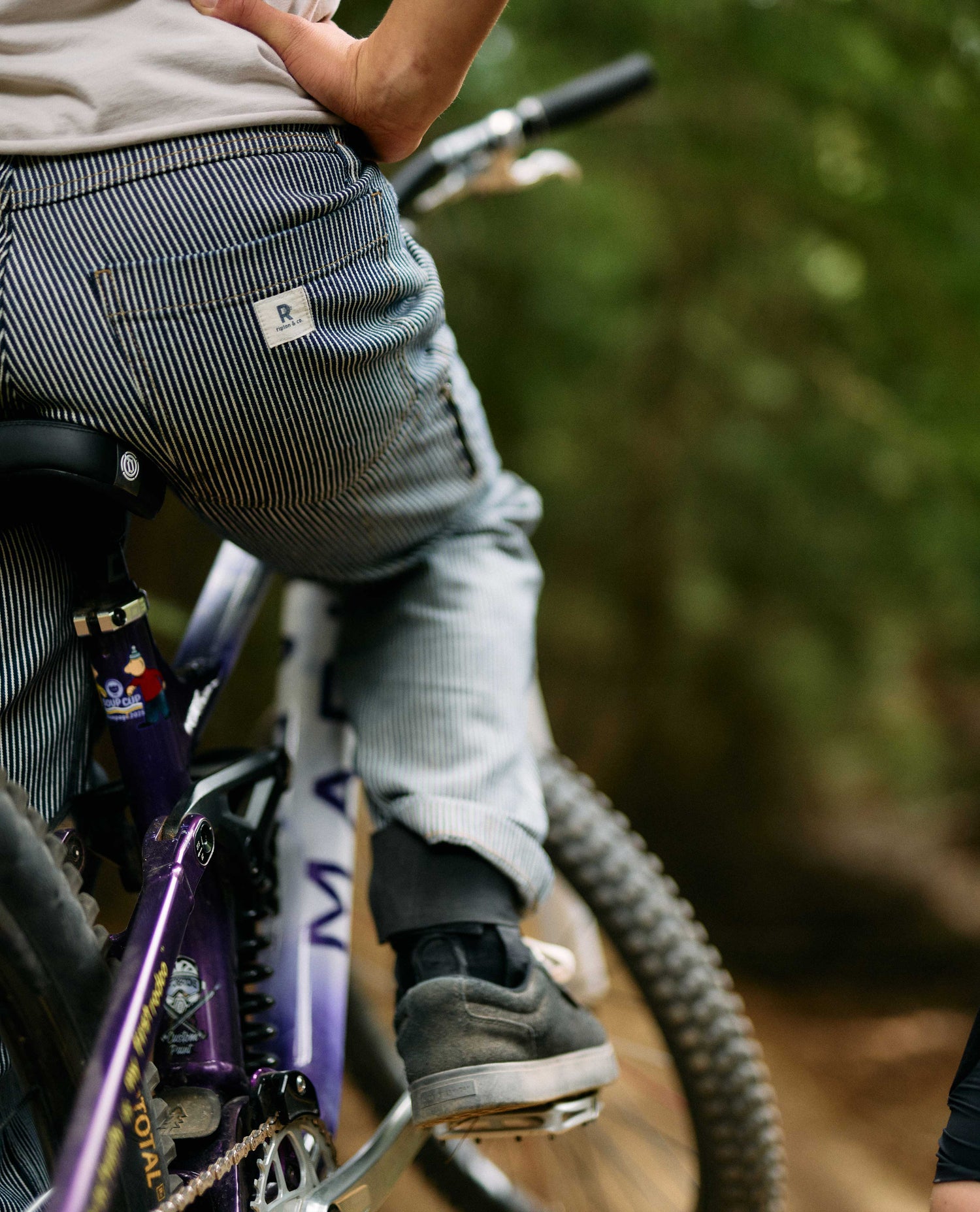 Person riding a bicycle with a blurred natural background