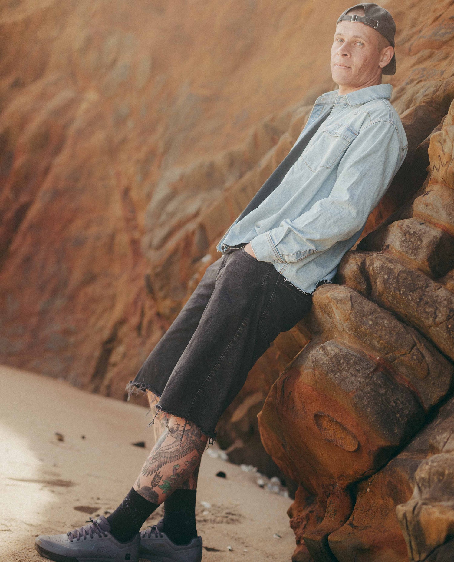 Man sitting on a rock with a desert landscape in the background