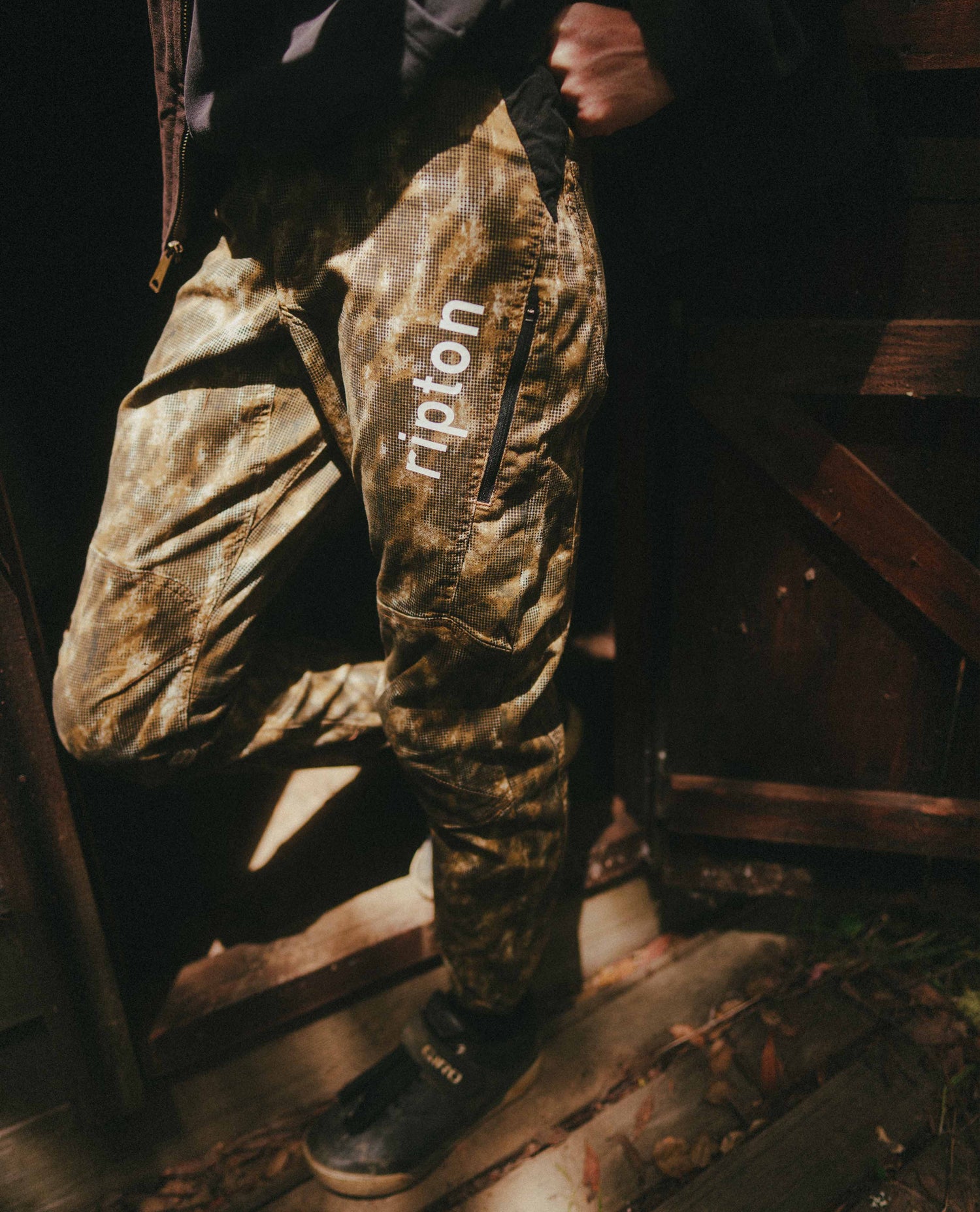 Dot camo bike pant in a dark moody shed